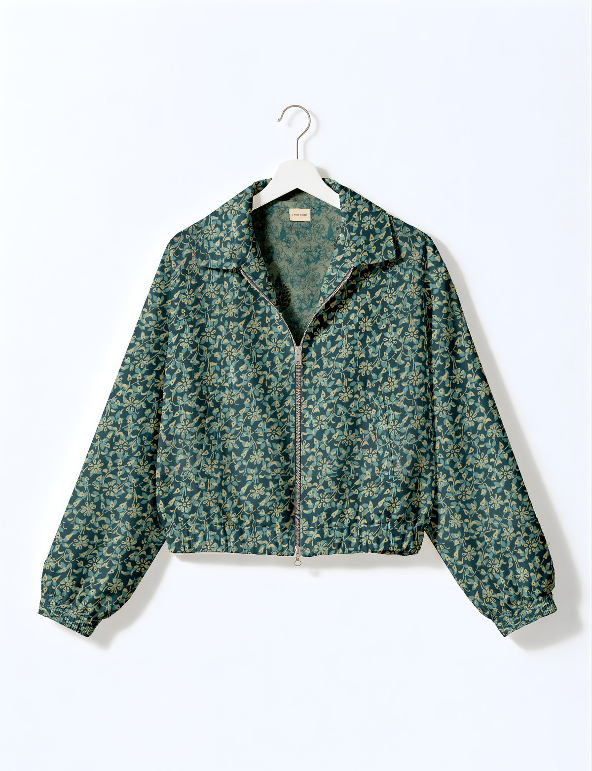 Brown floral bomber jacket with front zipper, elastic cuffs and hem, hanging on white hanger, red floral inner lining visible