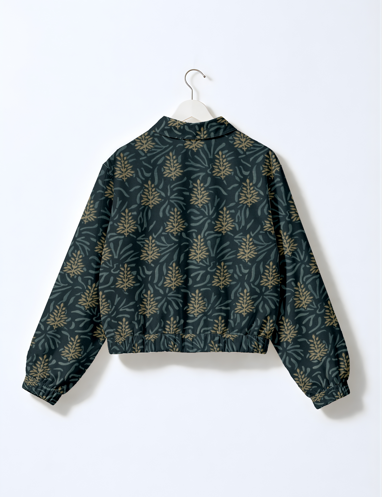 Women's cropped bomber jacket with twin metallic front zippers, welt pockets, elasticated hem and cuffs, and contrast sari print lining.