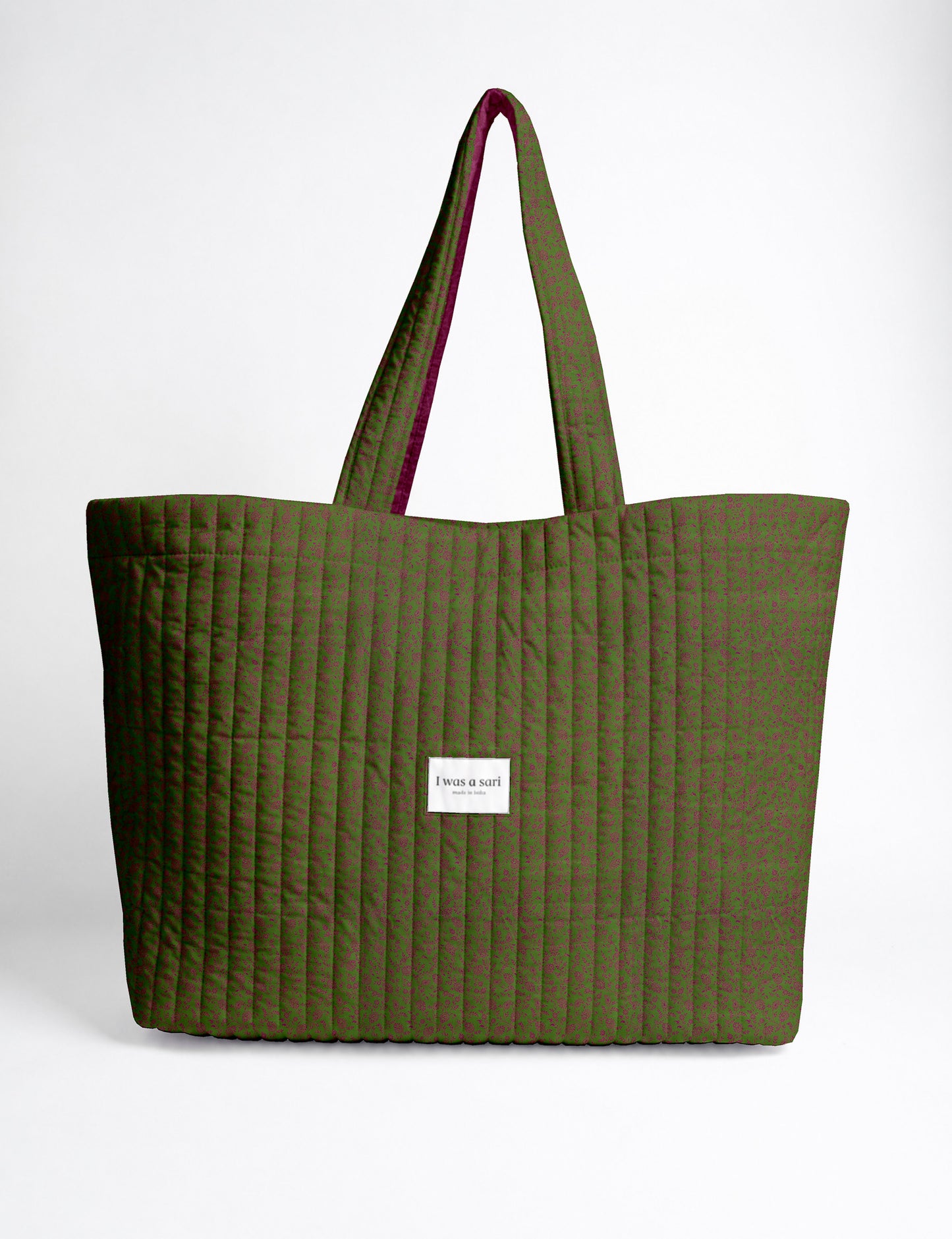 Quilted yellow tropical patterned beach bag with long handles and white label reading "I was a sari" front view