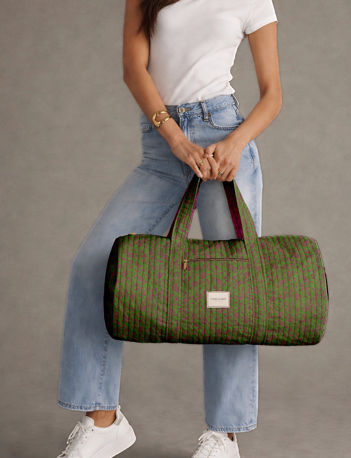 Brown paisley quilted bowling bag with dual handles, front zipper pocket, and "I was a sari" label on front side
