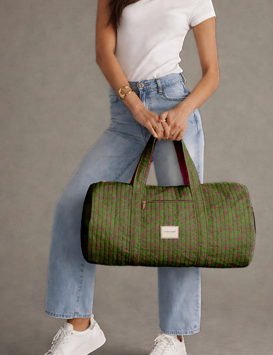 Brown paisley quilted bowling bag with dual handles, front zipper pocket, and "I was a sari" label on front side