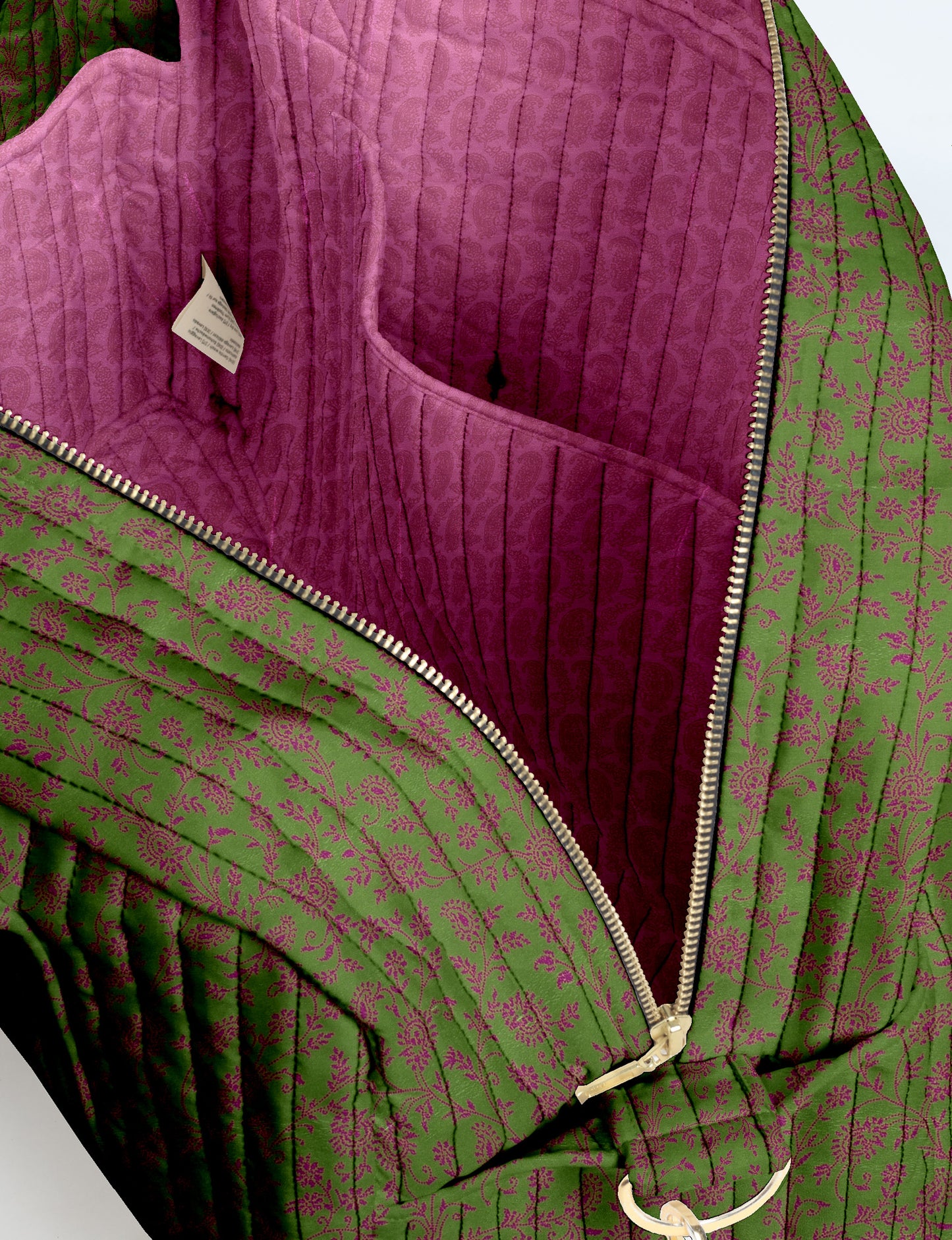 Brown quilted duffle bag with paisley pattern, front zip pocket, dual handles, and label reading "I was a sari"