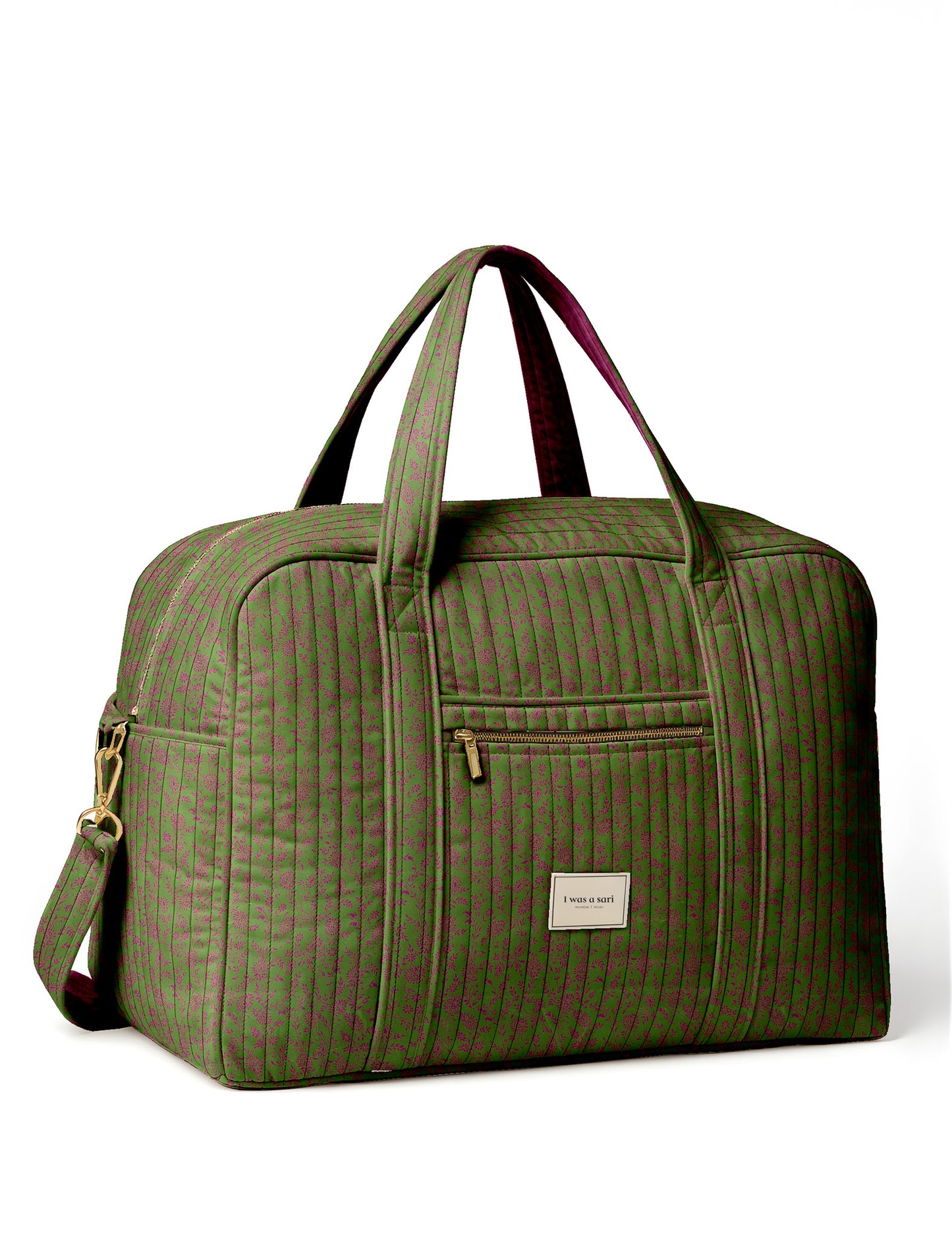 Brown quilted duffle bag with paisley pattern, front zip pocket, dual handles, and label reading "I was a sari"
