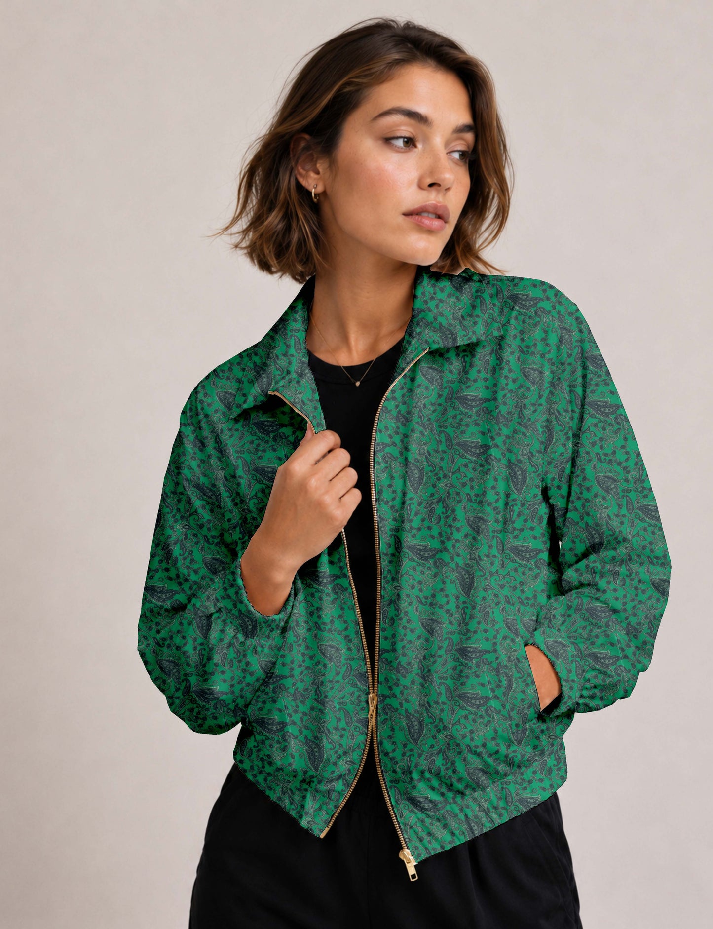 Woman wearing a yellow floral bomber jacket with front zipper, elastic cuffs, and side pockets, shown from front view