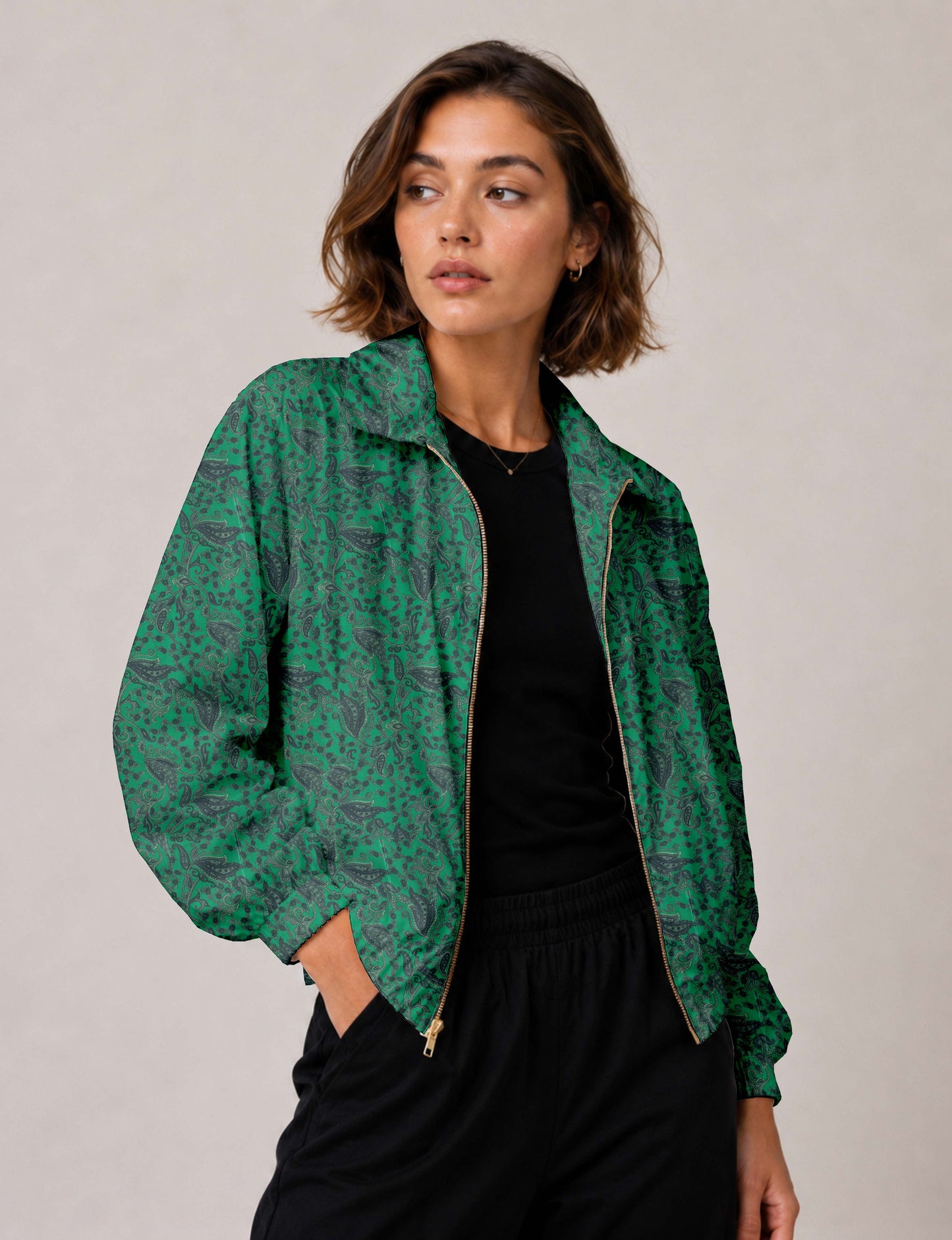 Woman wearing a yellow floral bomber jacket with front zipper, elastic cuffs, and side pockets, shown from front view