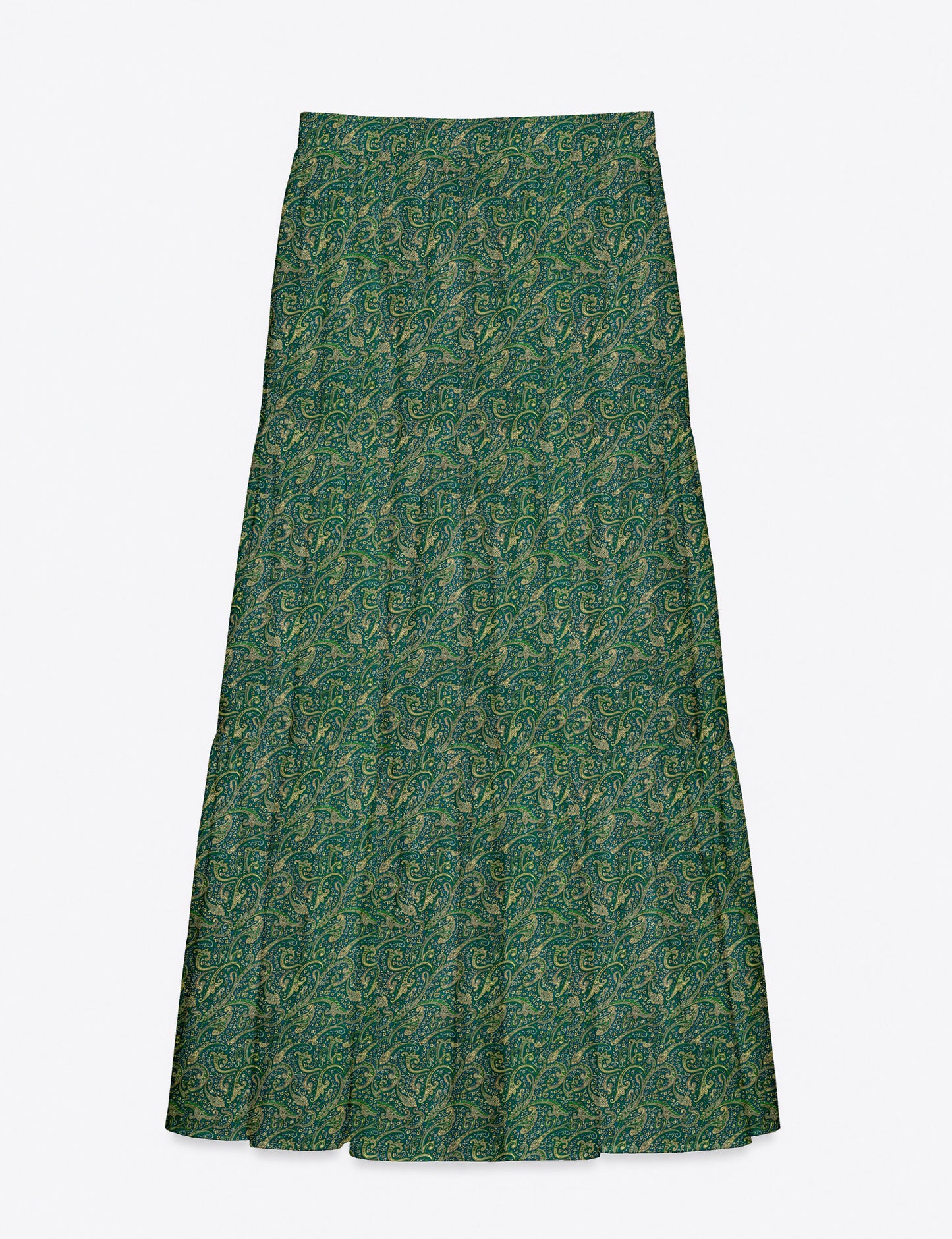 Woman wearing a yellow midi tiered skirt with a small geometric pattern, shown from the back, paired with beige top and