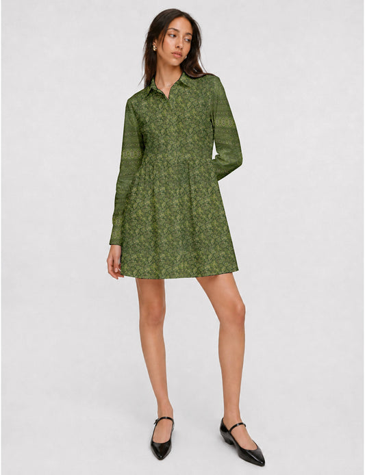 Short shirt dress with a relaxed A-line silhouette, point collar, partial button placket, gathered waist, side pockets, and full-length cuffed sleeves.
