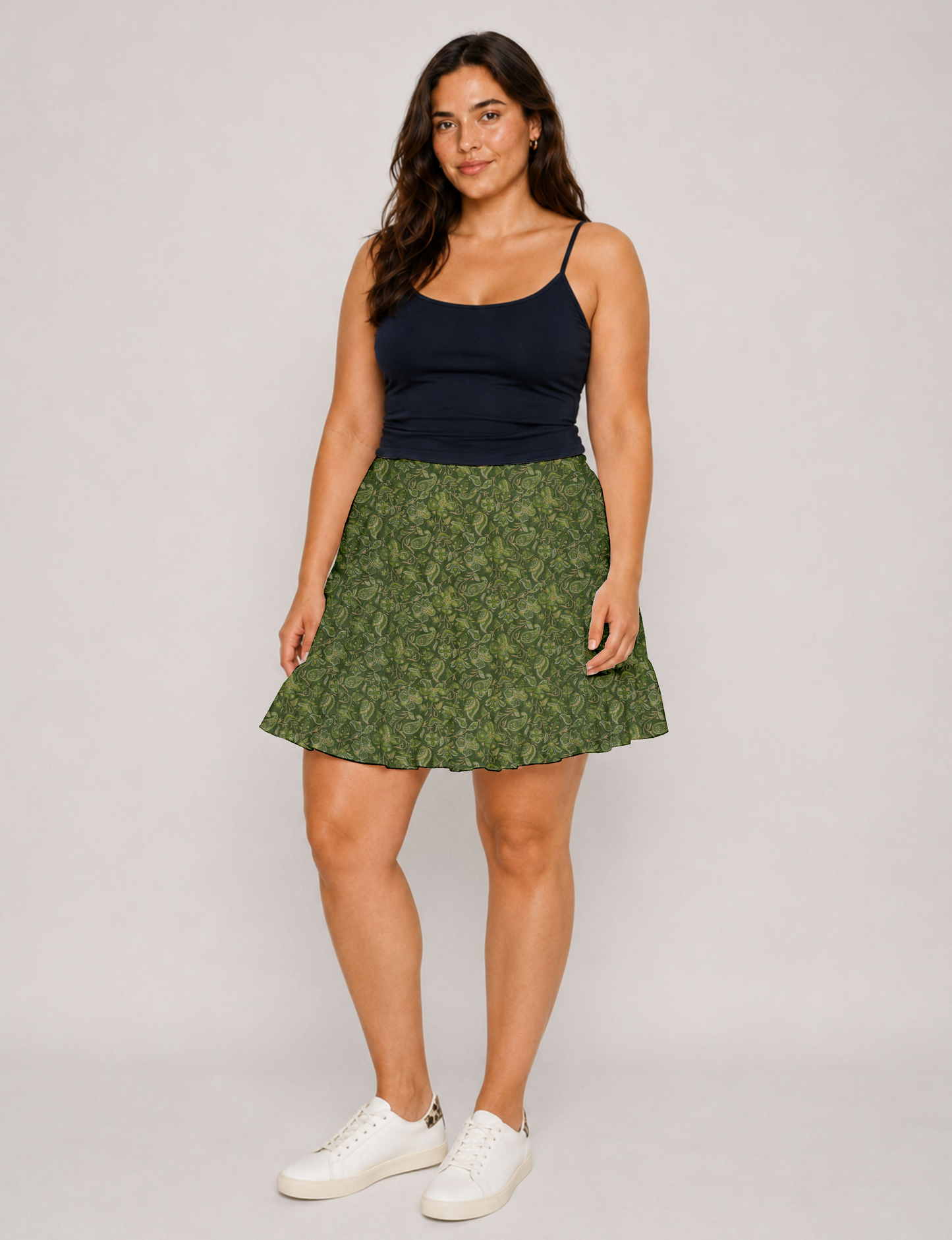 Short tiered skirt with a fitted waistband, knife pleats, softly flared silhouette, side seam pockets, and above-the-knee length.