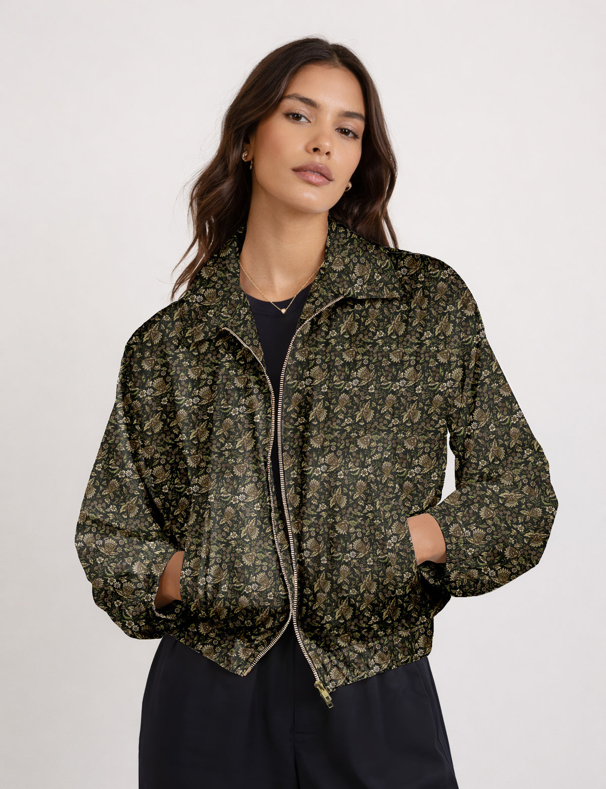 Woman wearing a yellow floral bomber jacket with front zipper, elastic cuffs, and side pockets, shown from front view