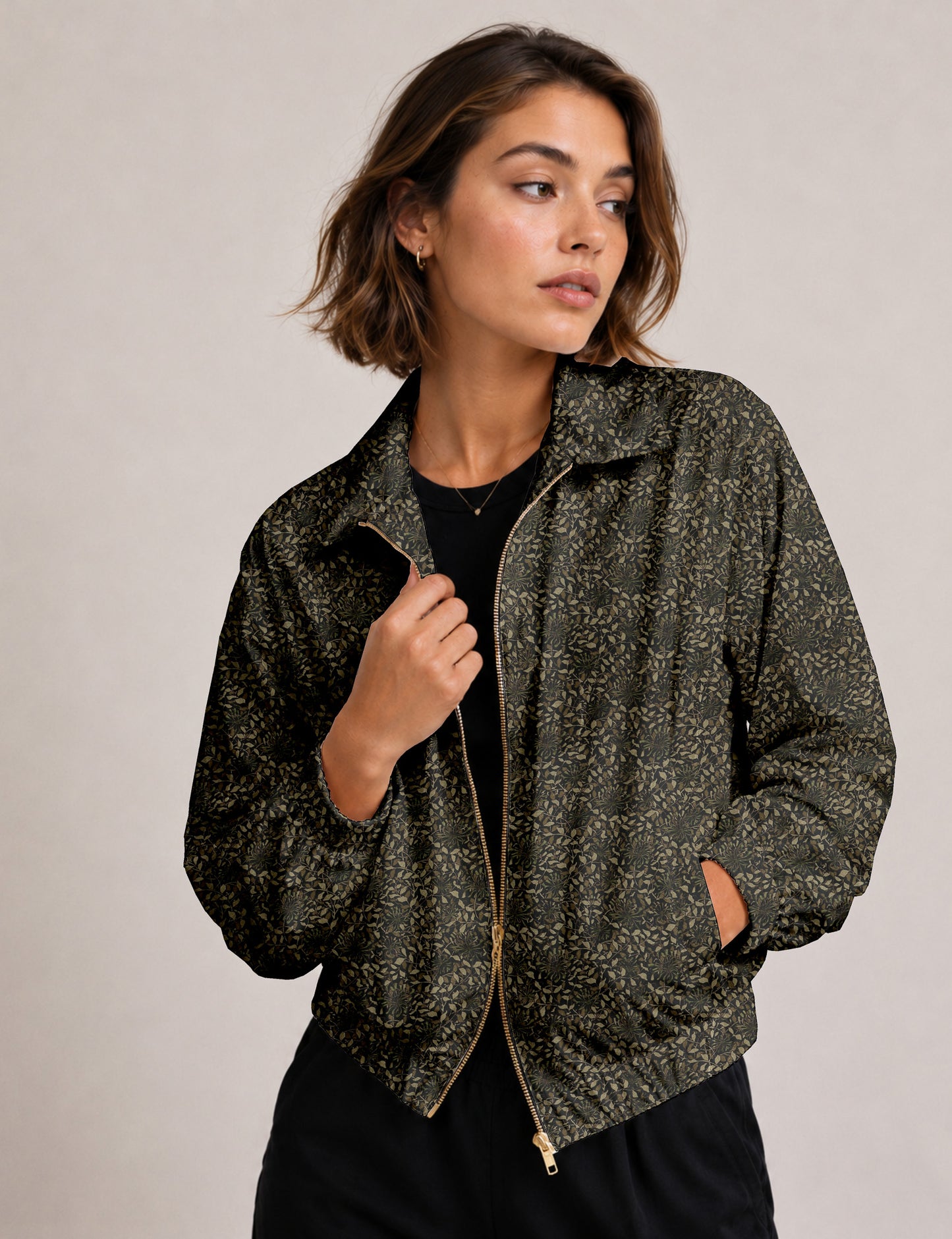 Brown floral bomber jacket with front zipper, elastic cuffs and hem, hanging on white hanger, red floral inner lining visible