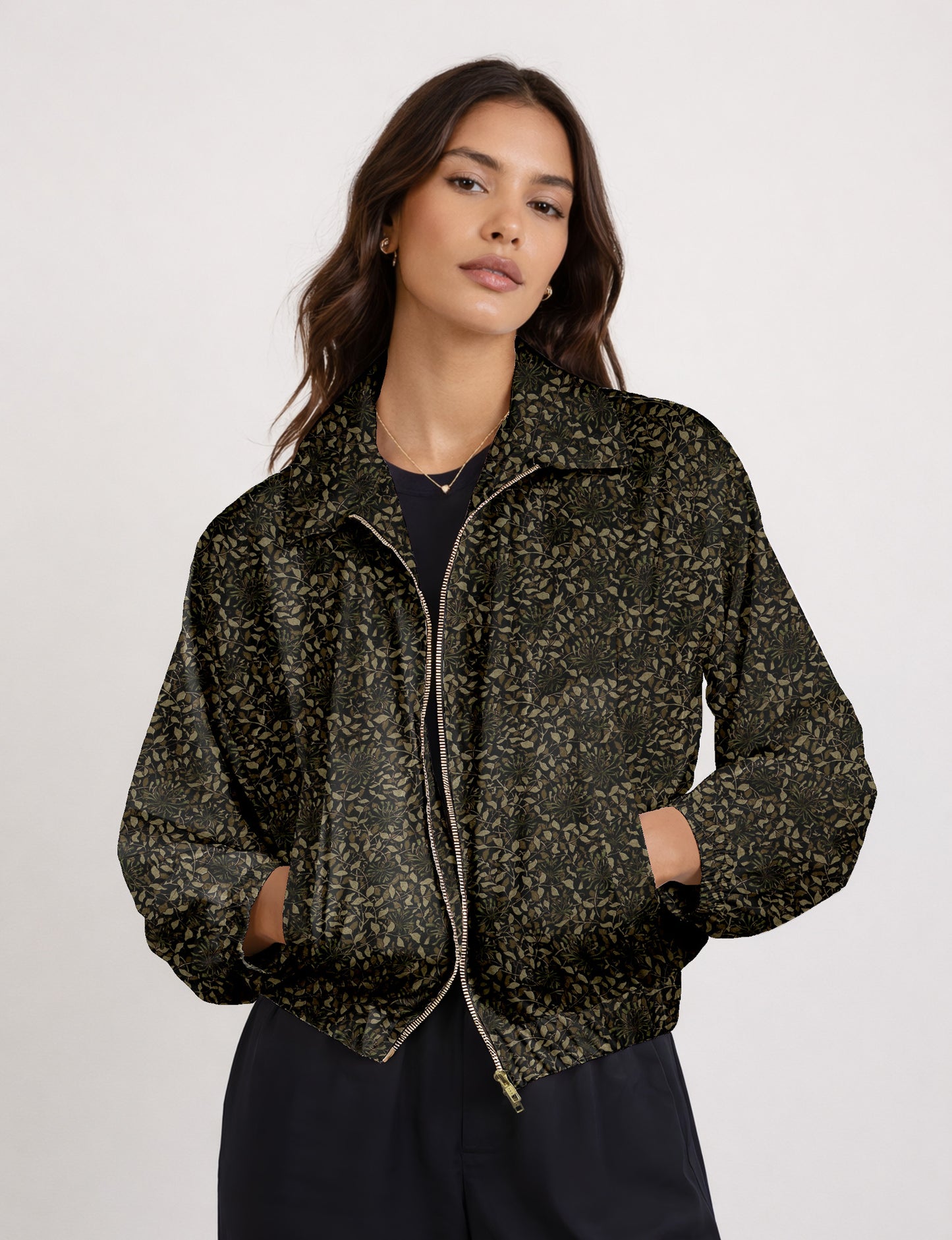 Woman wearing a yellow floral bomber jacket with front zipper, elastic cuffs, and side pockets, shown from front view