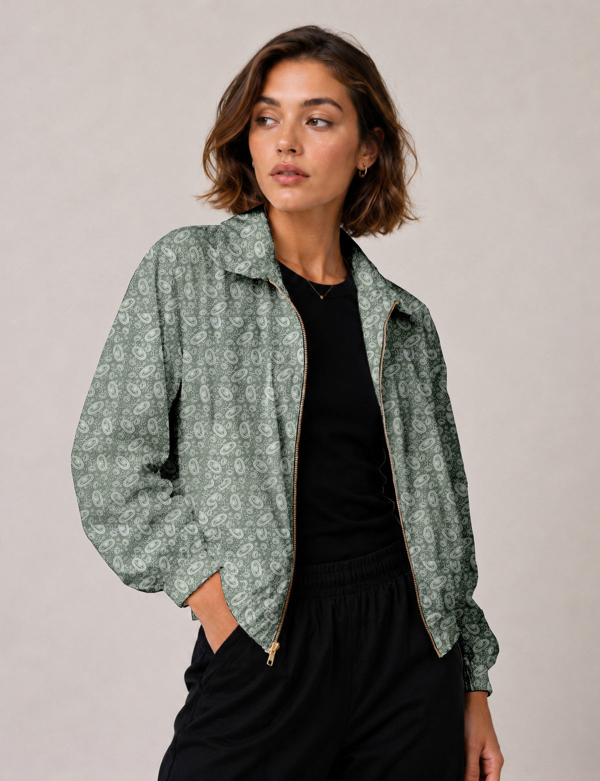 Brown floral bomber jacket with front zipper, elastic cuffs and hem, hanging on white hanger, red floral inner lining visible