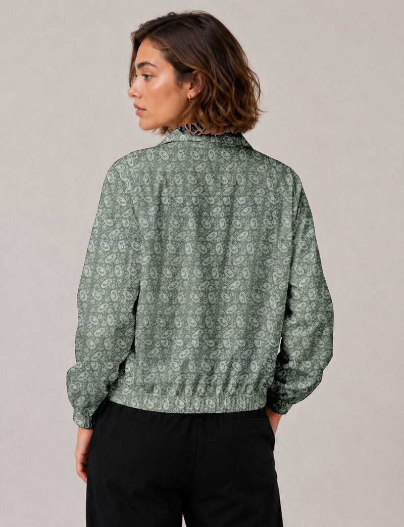 Woman wearing a yellow floral bomber jacket with front zipper, elastic cuffs, and side pockets, shown from front view