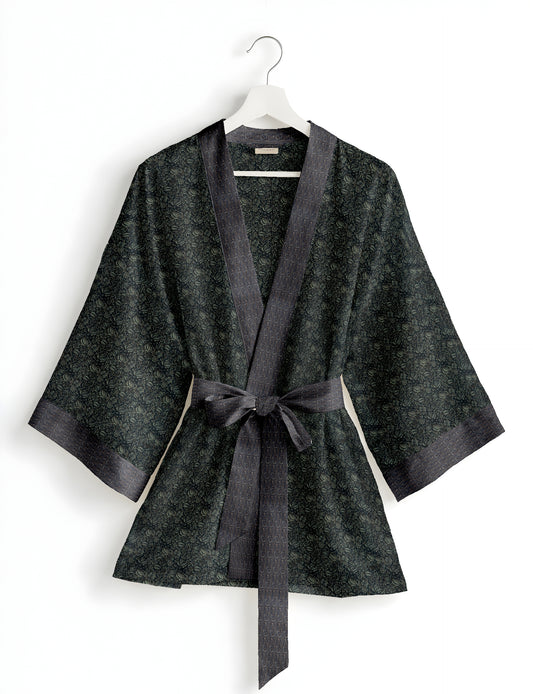 Short kimono robe with wrap front, V-neckline, wide sleeves, waist tie, and concealed skort detail.