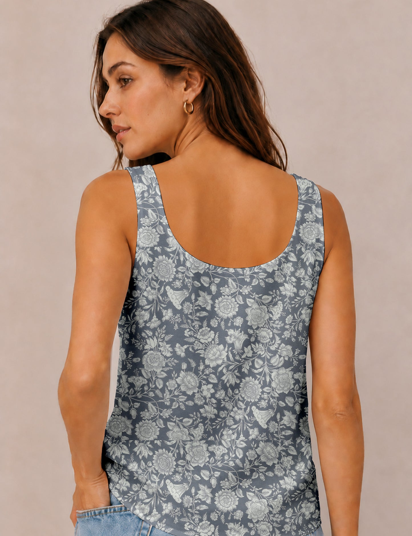 Women's sleeveless blouse with a relaxed straight fit, wide scoop neckline, deep scoop back, and hip-length silhouette.