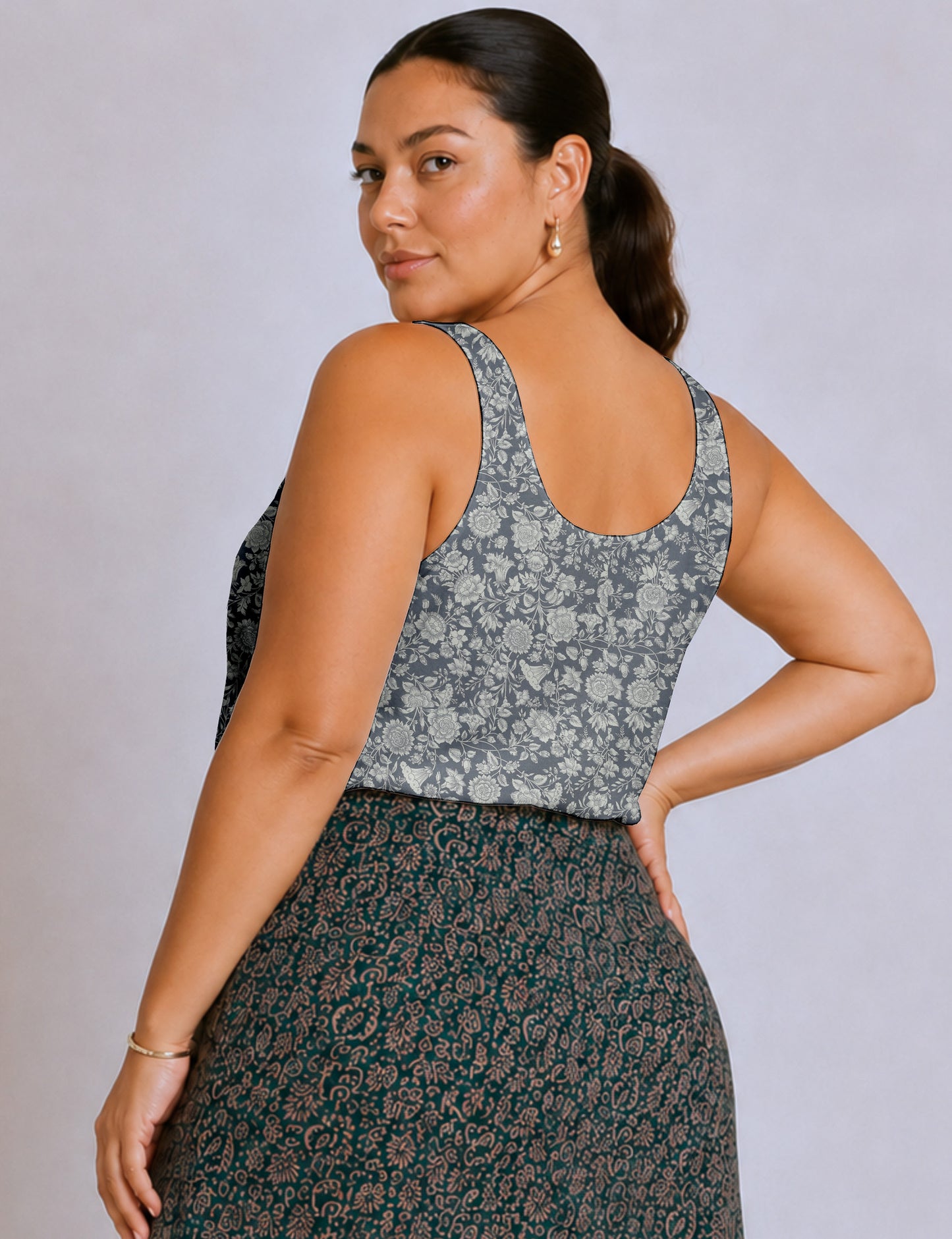 Women's sleeveless blouse with a relaxed straight fit, wide scoop neckline, deep scoop back, and hip-length silhouette.