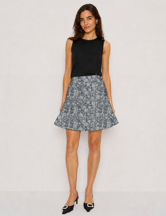Short tiered skirt with a fitted waistband, knife pleats, softly flared silhouette, side seam pockets, and above-the-knee length.