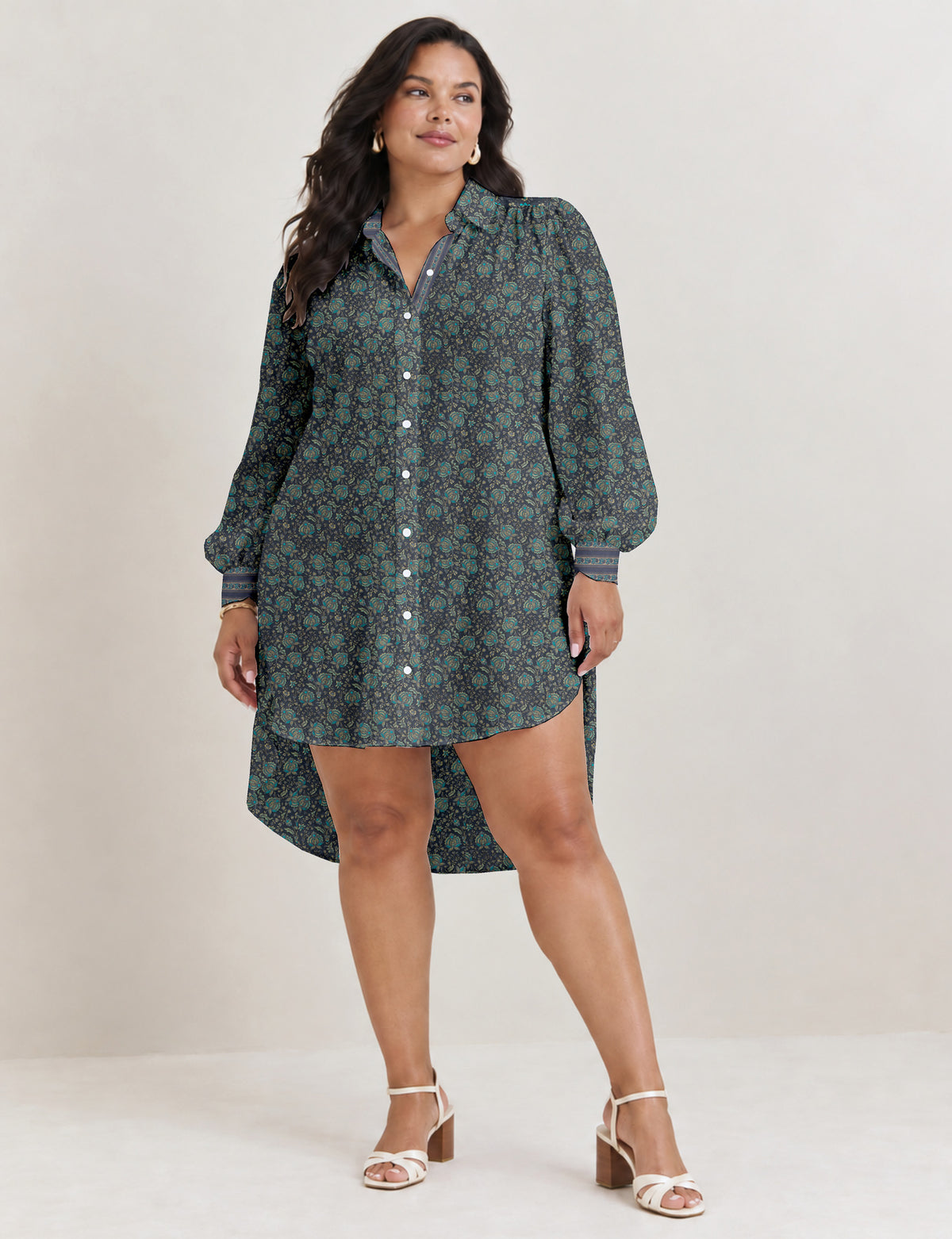 High low shirt with a relaxed fit, button-down front, classic collar, gathered shoulders and full-length blouson sleeves.