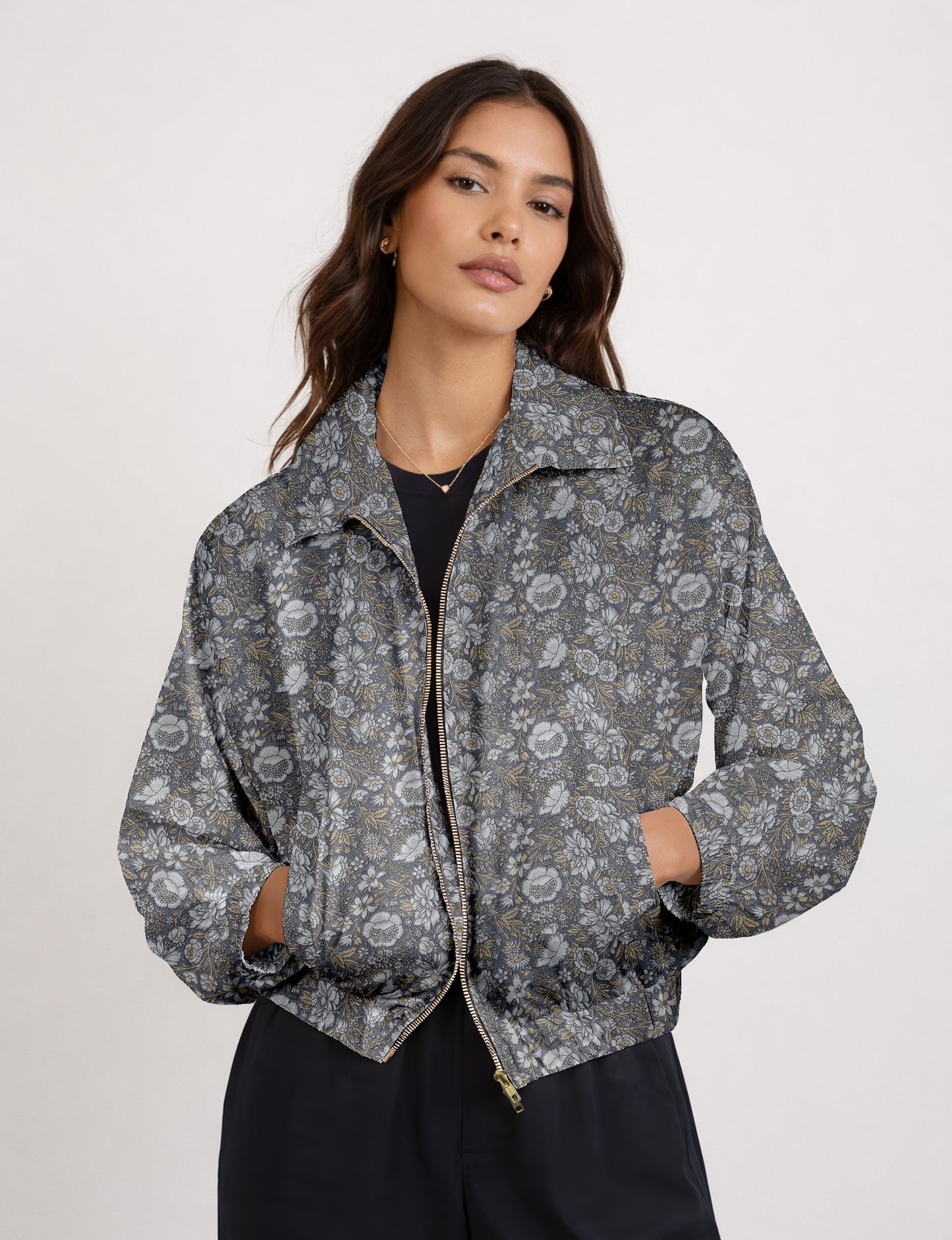 Brown floral bomber jacket with front zipper, elastic cuffs and hem, hanging on white hanger, red floral inner lining visible