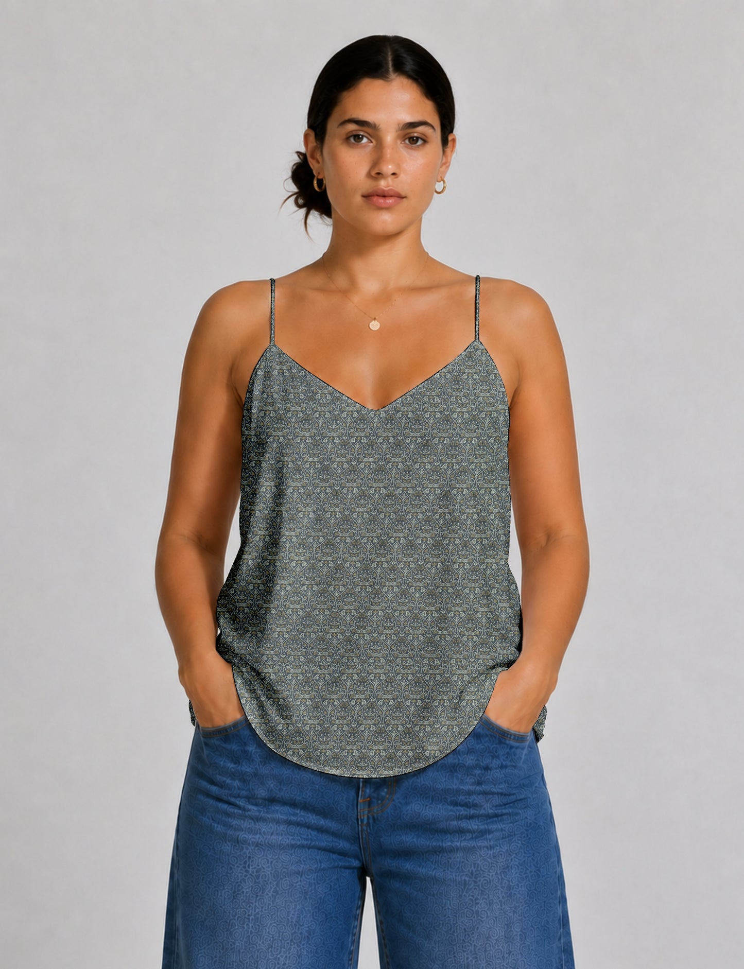 Women's sleeveless slip top with a relaxed straight fit, soft V-neckline, deep V-back, and delicate spaghetti straps.