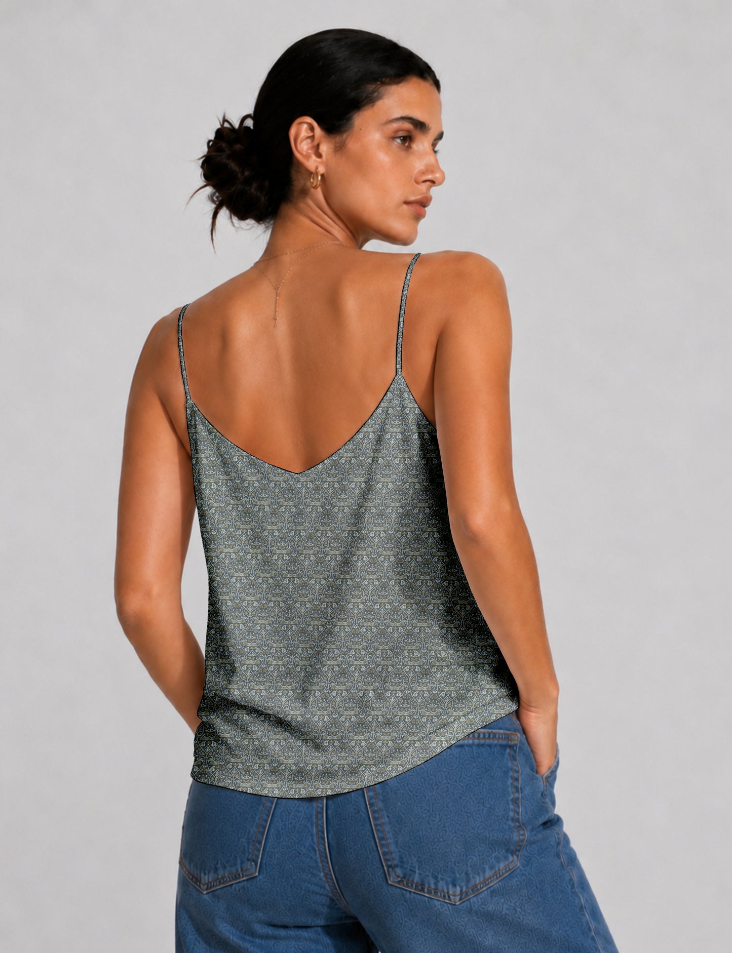 Women's sleeveless slip top with a relaxed straight fit, soft V-neckline, deep V-back, and delicate spaghetti straps.