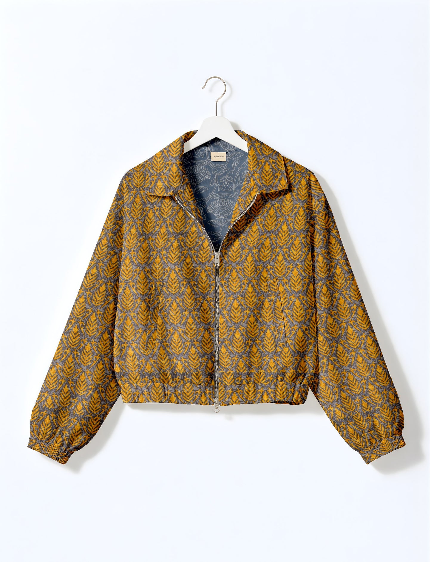 Upcycled Bomber Jacket made from recycled sari materials, featuring a cute cropped shape, elasticated hem and cuffs, and contrast sari print lining. Sustainable apparel promoting eco-friendly fashion and ethical clothing.