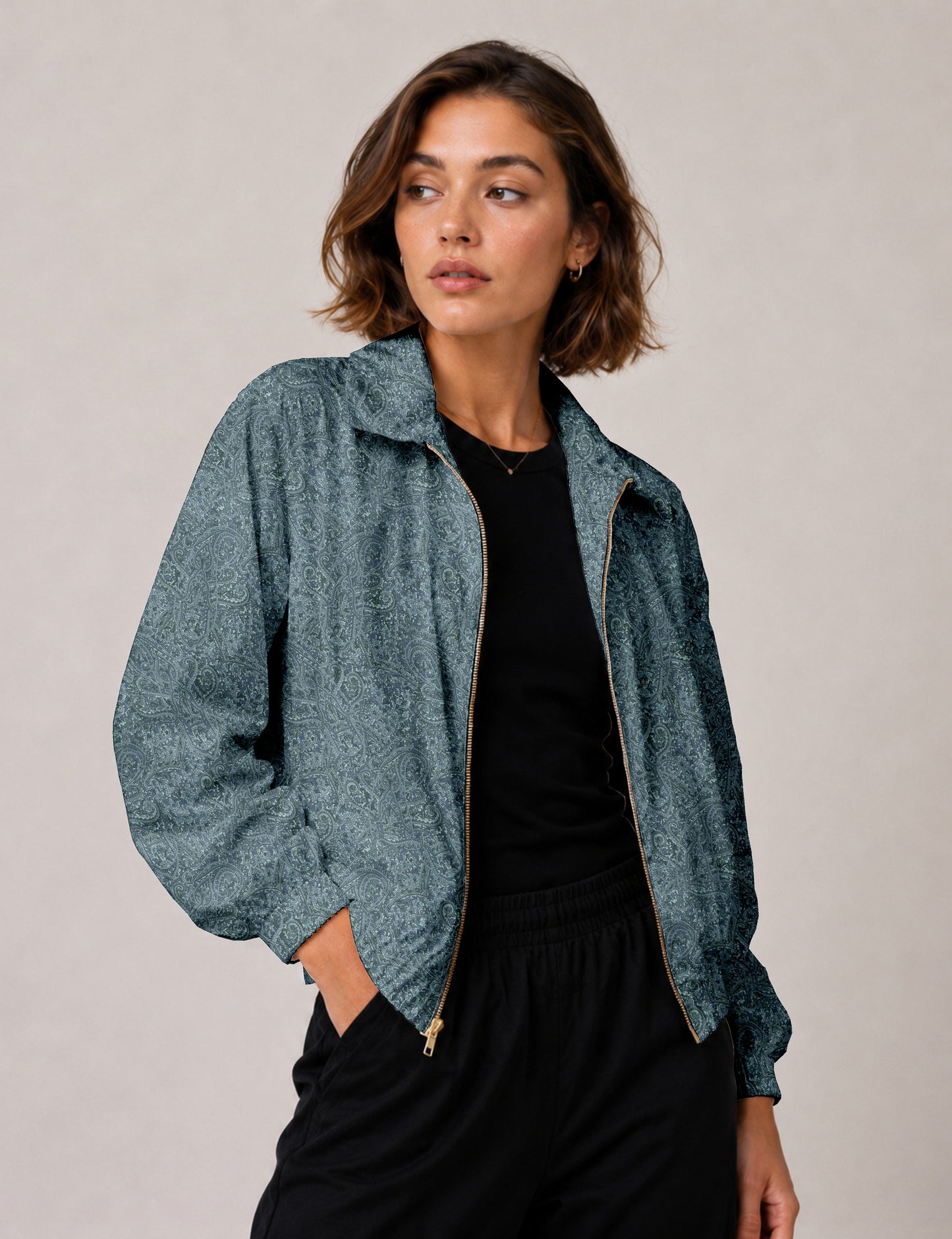 Woman wearing a yellow floral bomber jacket with front zipper, elastic cuffs, and side pockets, shown from front view