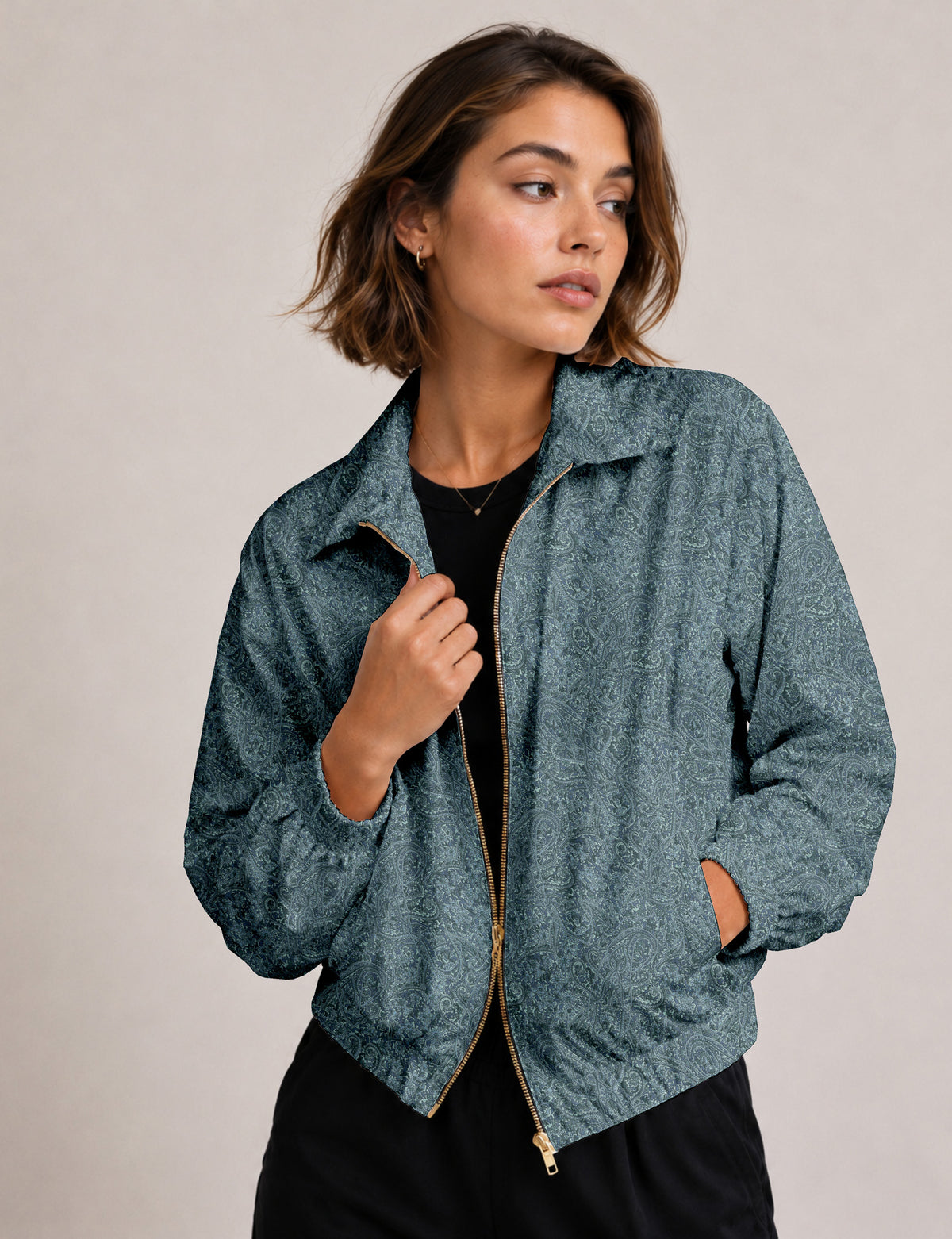 Woman wearing a yellow floral bomber jacket with front zipper, elastic cuffs, and side pockets, shown from front view