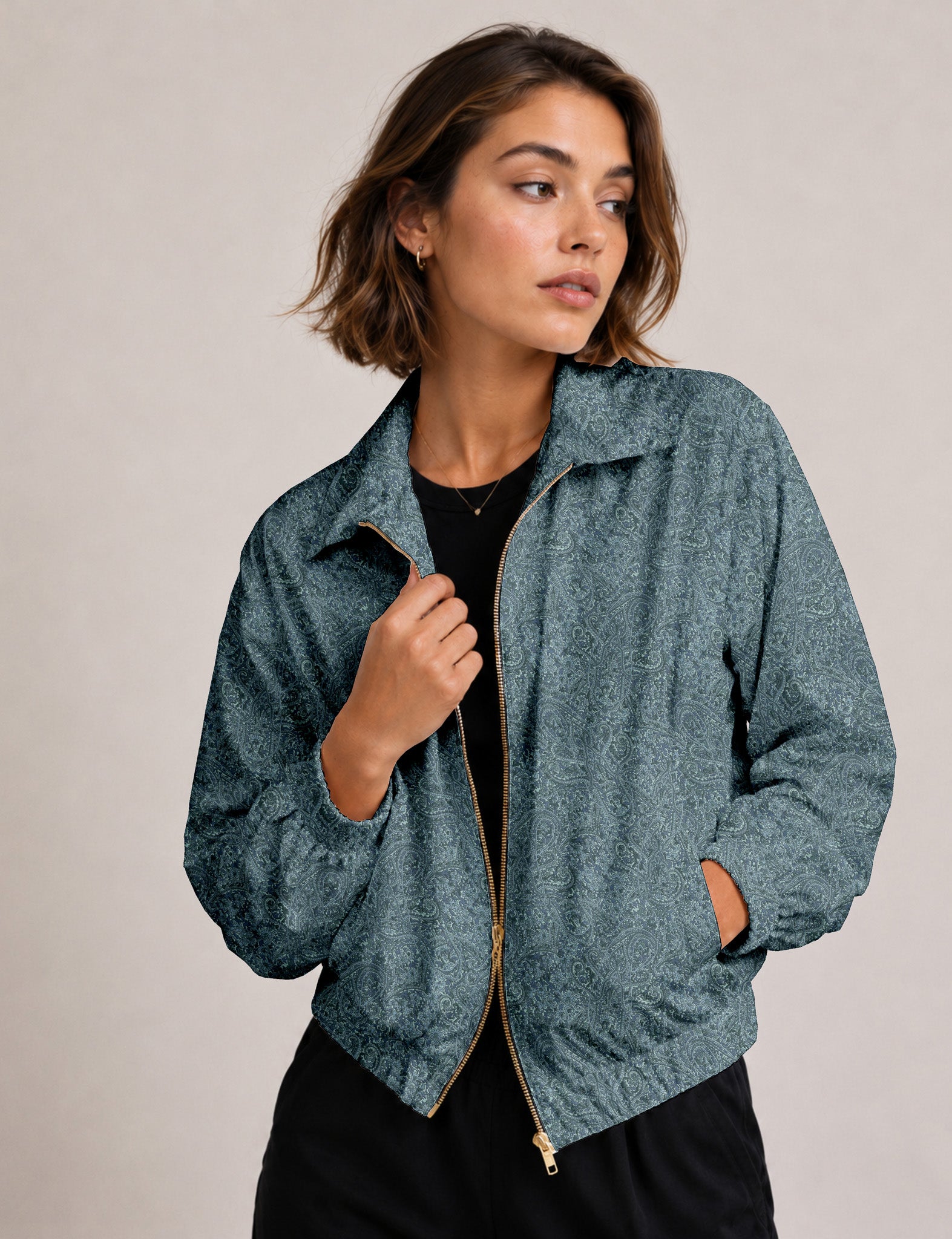 Woman wearing a yellow floral bomber jacket with front zipper, elastic cuffs, and side pockets, shown from front view
