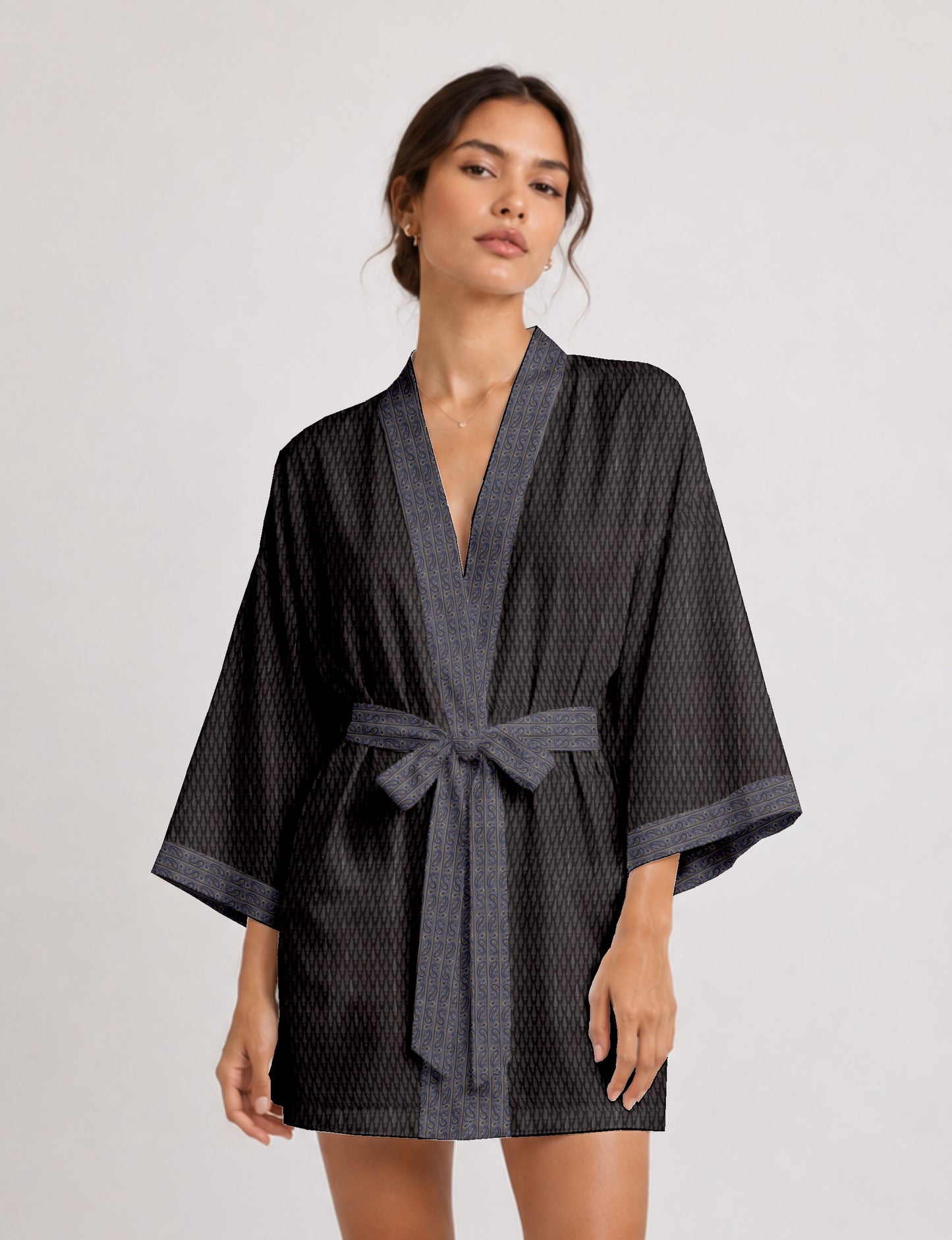Short kimono robe with wrap front, V-neckline, wide sleeves, waist tie, and concealed skort detail.