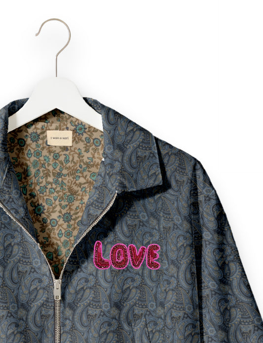 Love Bomber Jacket made from recycled fabric, featuring hand-stitched Aari embroidery. A unique piece of zero-waste clothing, part of the circular fashion movement. Designed with upcycled materials for a stylish yet environmentally friendly clothing choice.