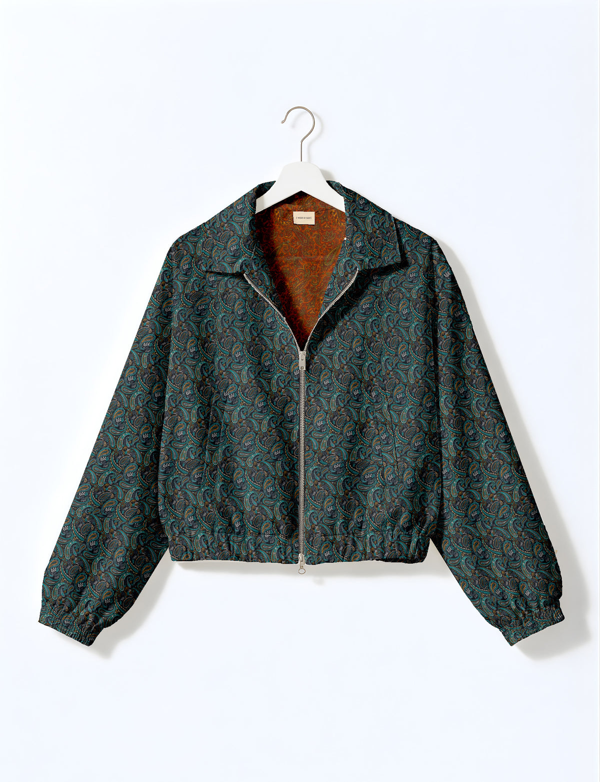 Brown floral bomber jacket with front zipper, elastic cuffs and hem, hanging on white hanger, red floral inner lining visible