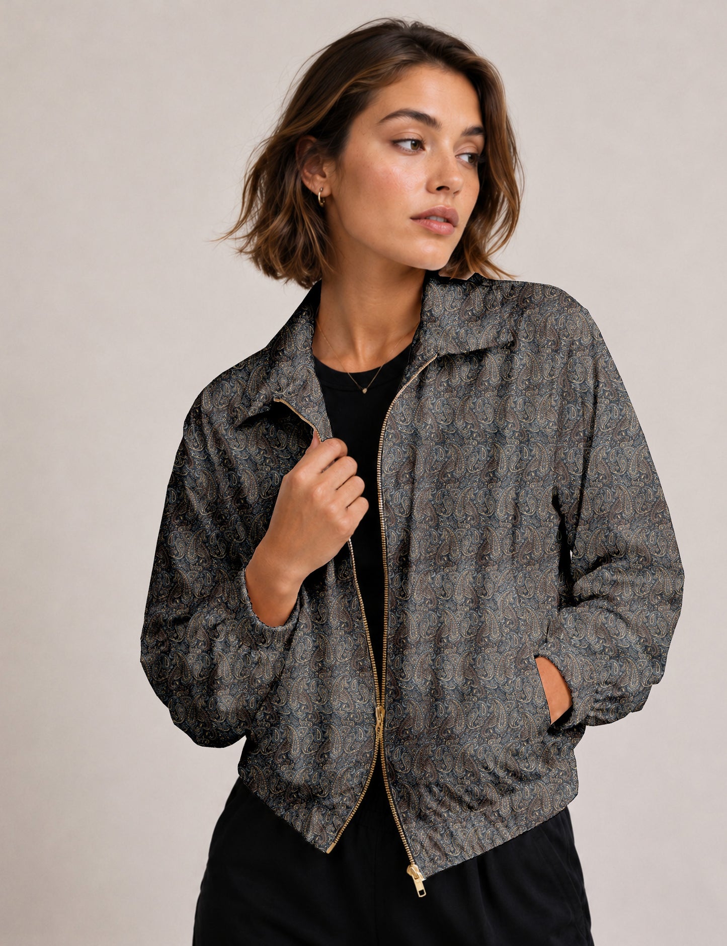 Woman wearing a yellow floral bomber jacket with front zipper, elastic cuffs, and side pockets, shown from front view