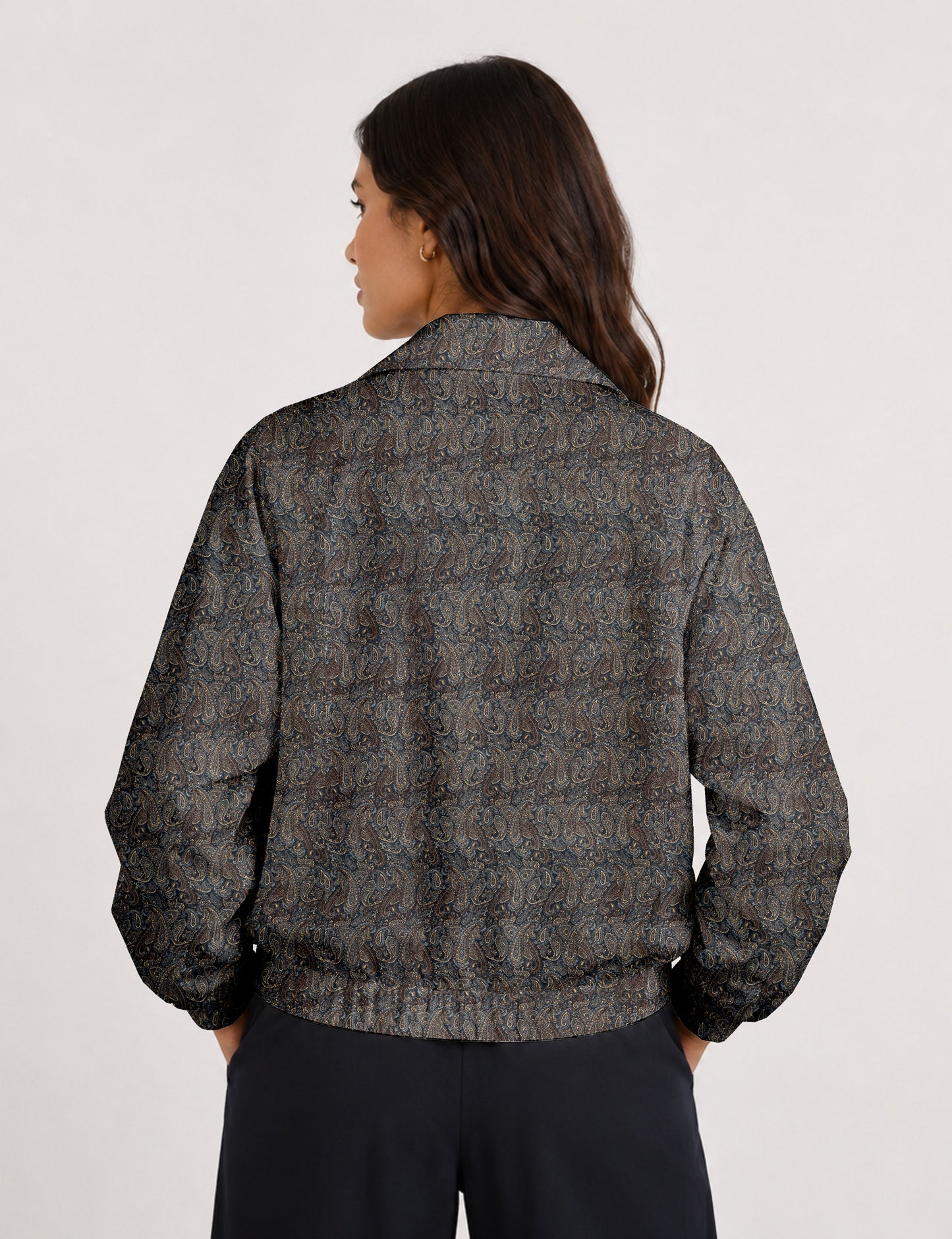 Woman wearing a yellow floral bomber jacket with front zipper, elastic cuffs, and side pockets, shown from front view