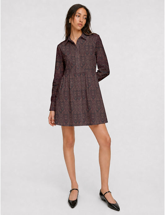 Short shirt dress with a relaxed A-line silhouette, point collar, partial button placket, gathered waist, side pockets, and full-length cuffed sleeves.