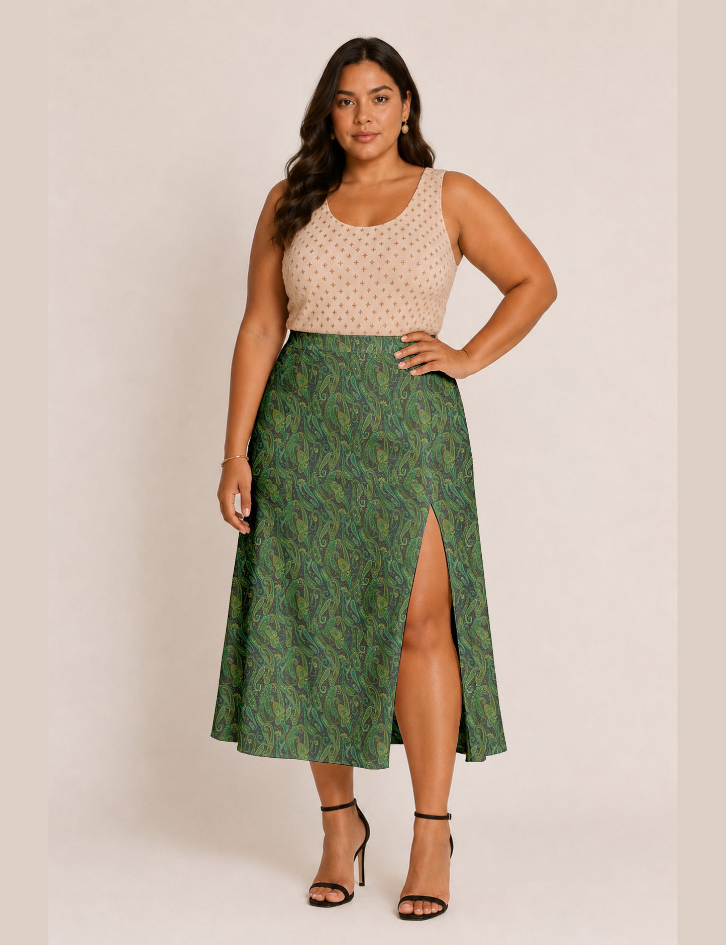 Woman wearing a yellow and black micro patterned A-line skirt with front slit, paired with beige sleeveless top and black