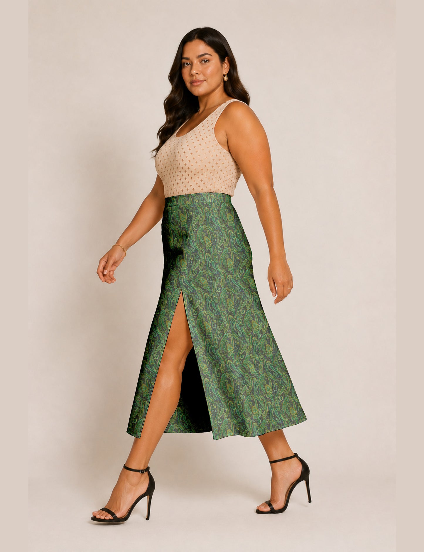 Woman wearing a yellow and black micro patterned A-line skirt with front slit, paired with beige sleeveless top and black