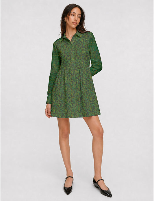 Short shirt dress with a relaxed A-line silhouette, point collar, partial button placket, gathered waist, side pockets, and full-length cuffed sleeves.