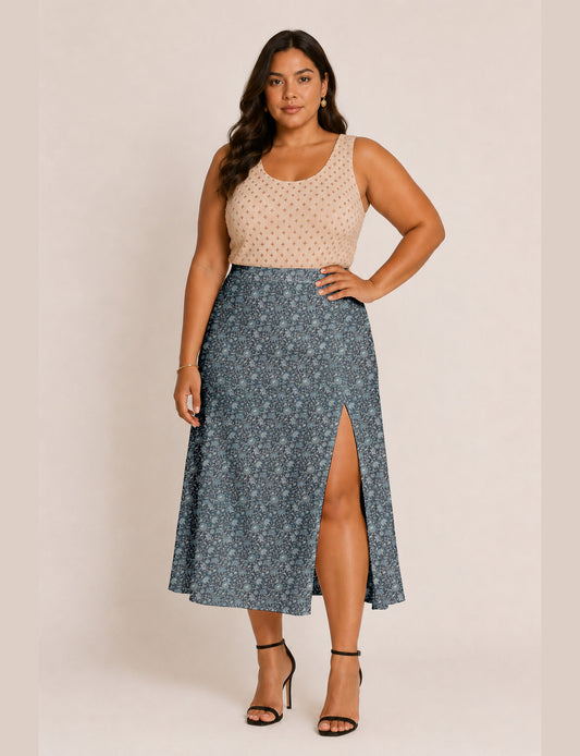 Woman wearing a yellow and black micro patterned A-line skirt with front slit, paired with beige sleeveless top and black
