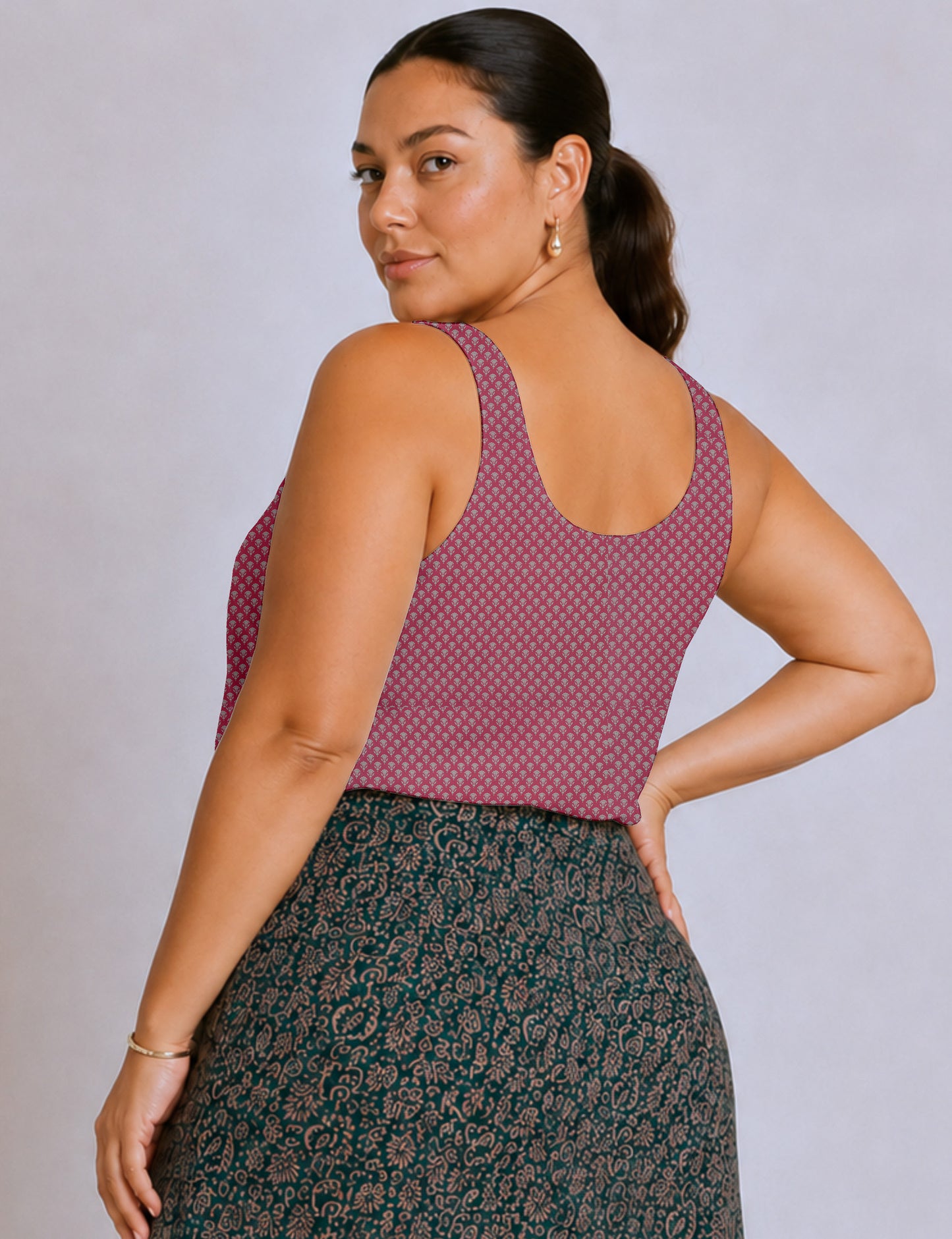 Women's sleeveless blouse with a relaxed straight fit, wide scoop neckline, deep scoop back, and hip-length silhouette.