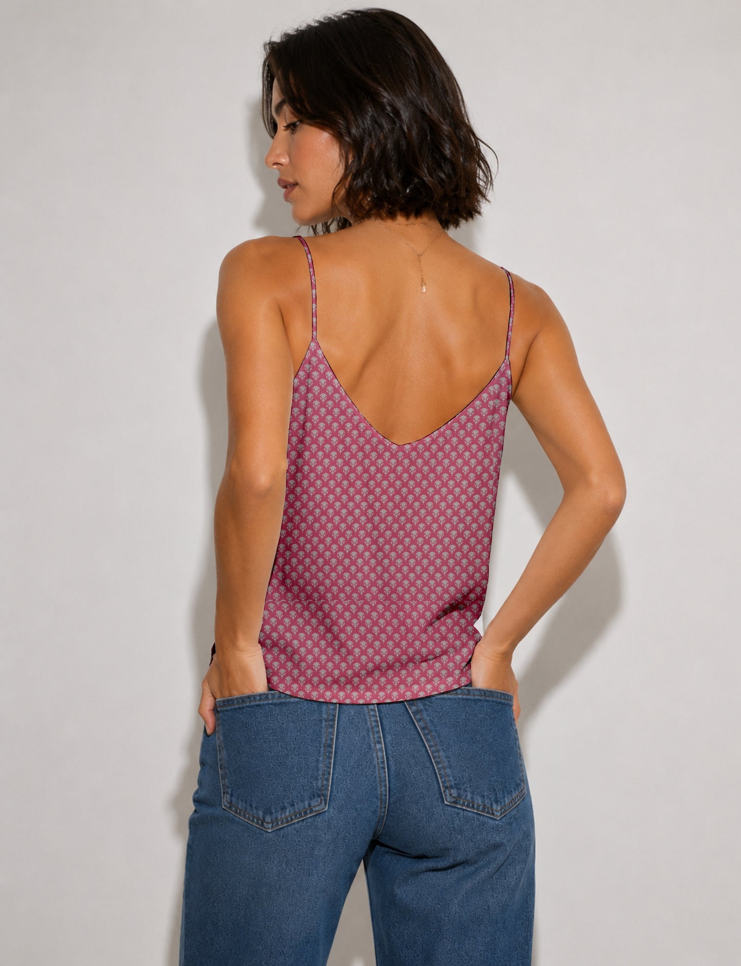 Women's sleeveless slip top with a relaxed straight fit, soft V-neckline, deep V-back, and delicate spaghetti straps.