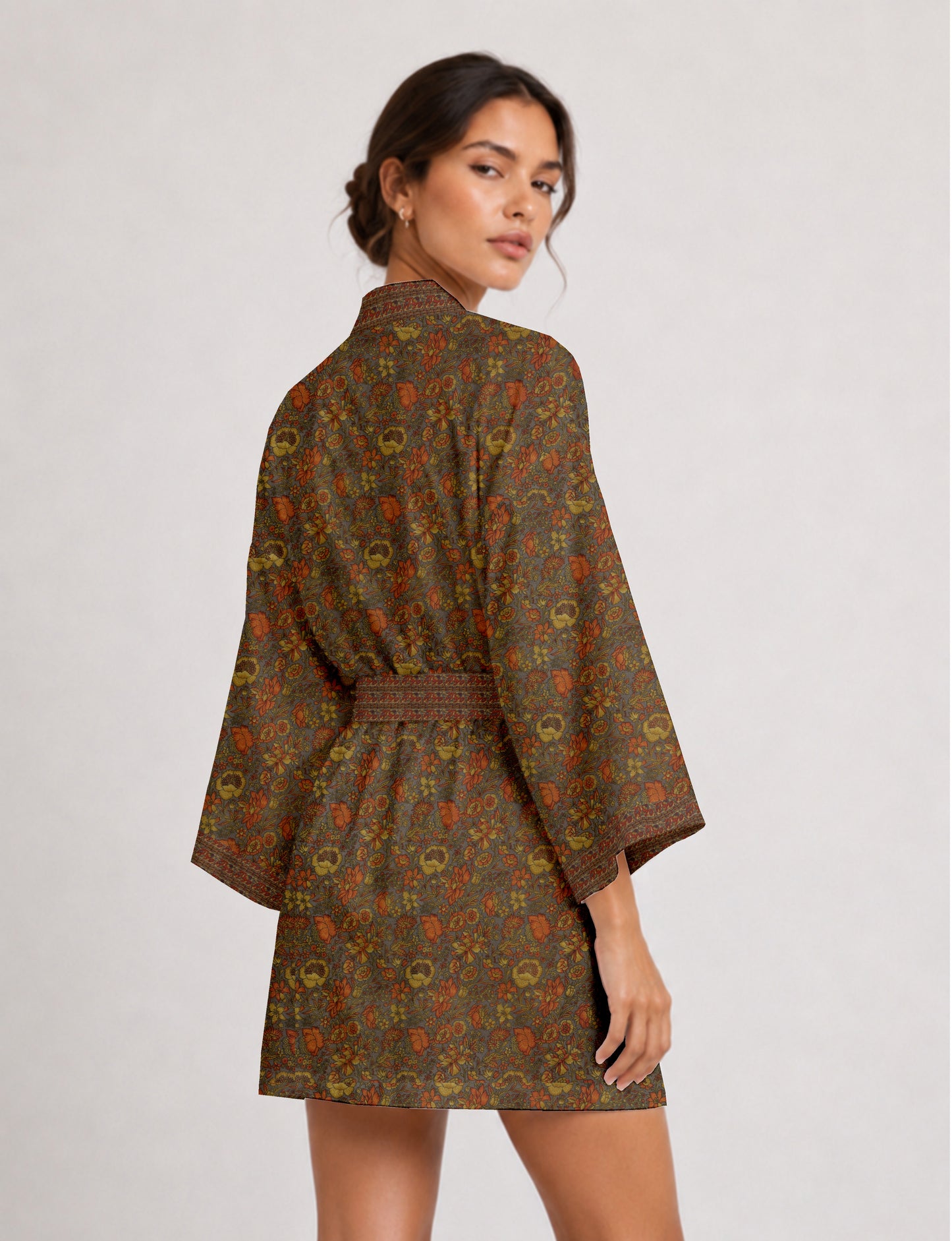 Short kimono robe with wrap front, V-neckline, wide sleeves, waist tie, and concealed skort detail.
