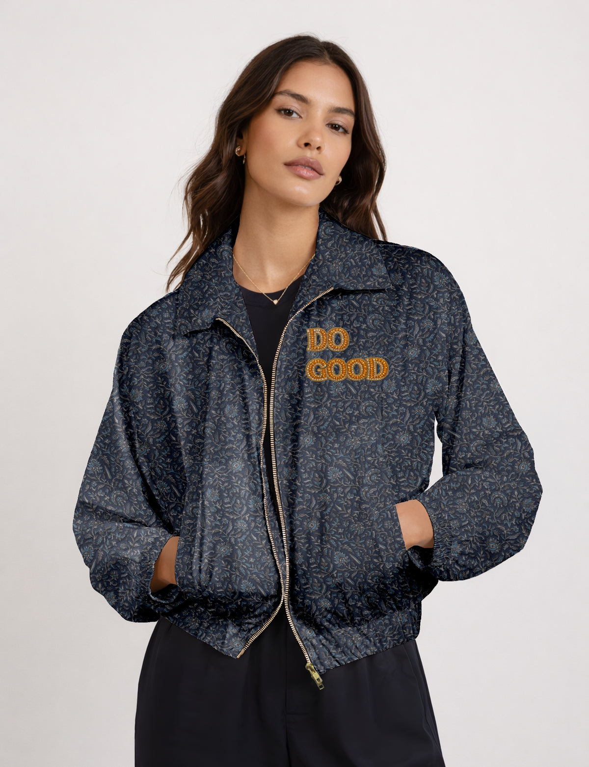 Gold cropped DO GOOD bomber jacket featuring hand-embroidered lettering on the left chest, contrasting inner lining and two functional pockets.