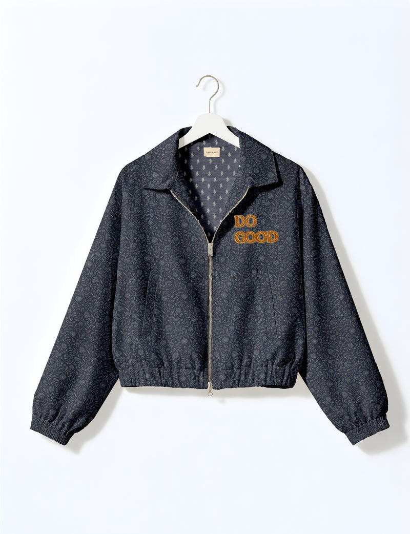 Gold cropped DO GOOD bomber jacket featuring hand-embroidered lettering on the left chest, contrasting inner lining and two functional pockets.
