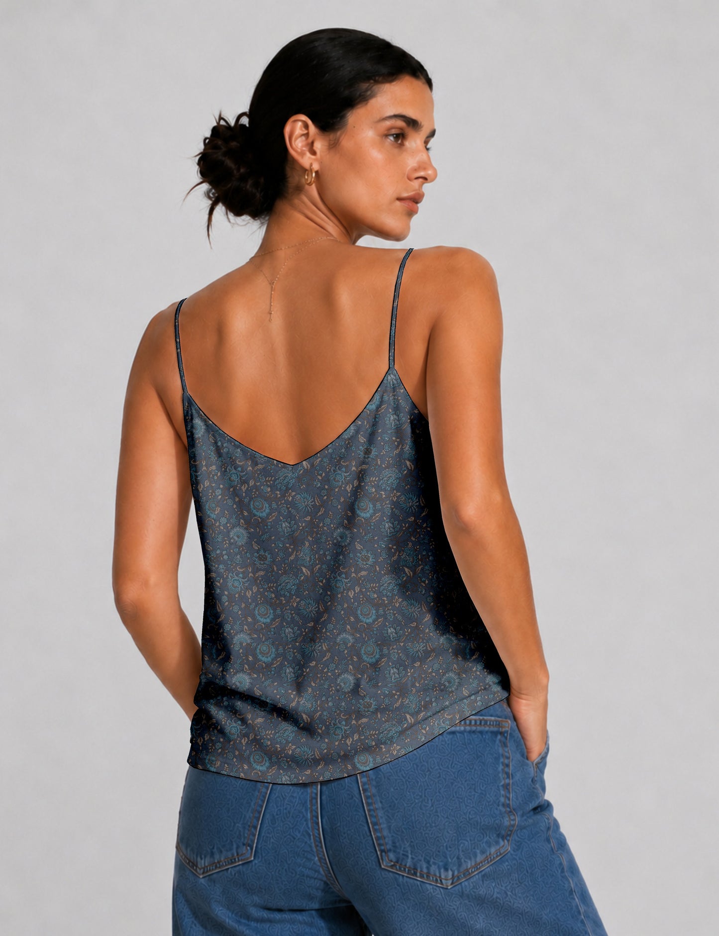 Women's sleeveless slip top with a relaxed straight fit, soft V-neckline, deep V-back, and delicate spaghetti straps.
