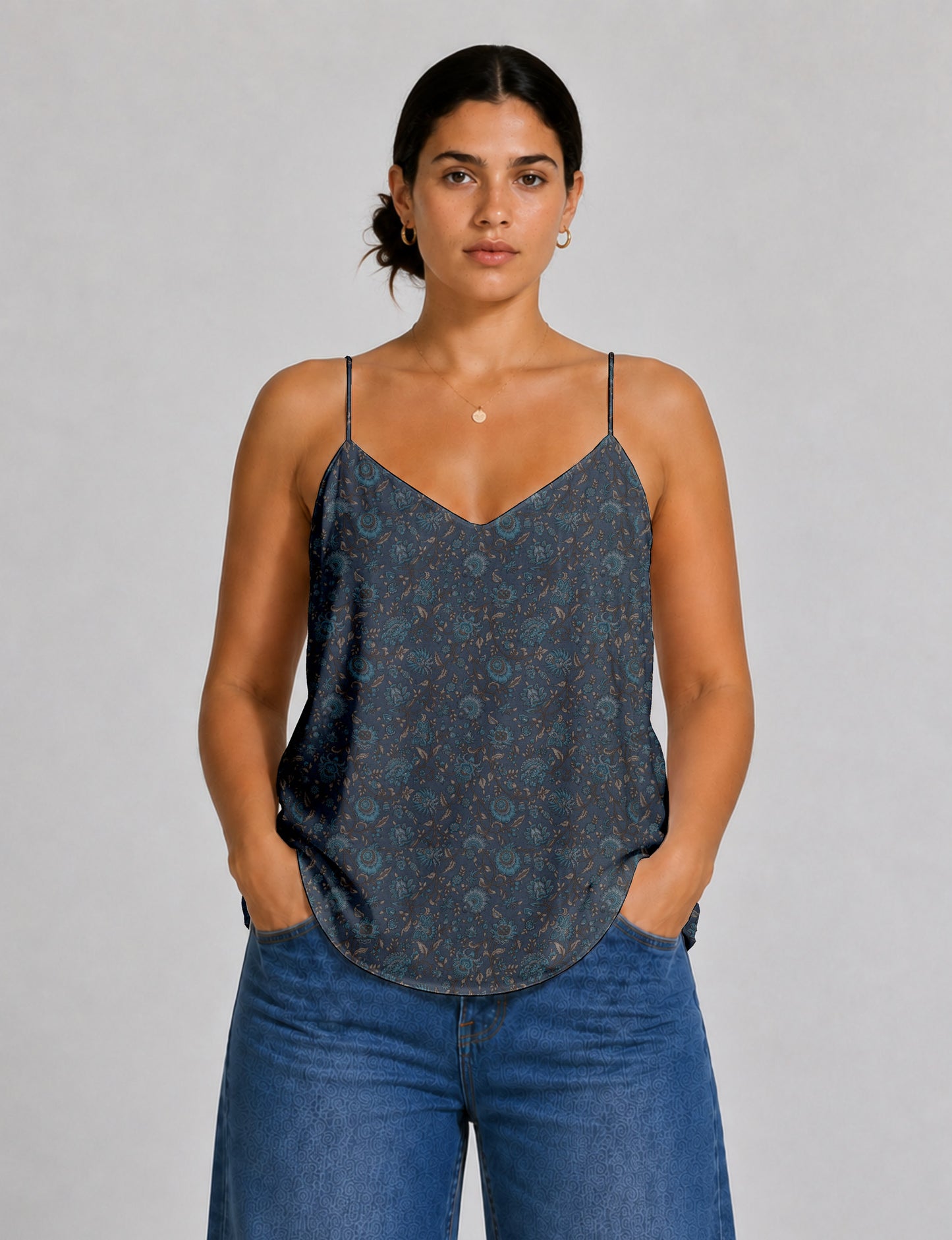 Women's sleeveless slip top with a relaxed straight fit, soft V-neckline, deep V-back, and delicate spaghetti straps.
