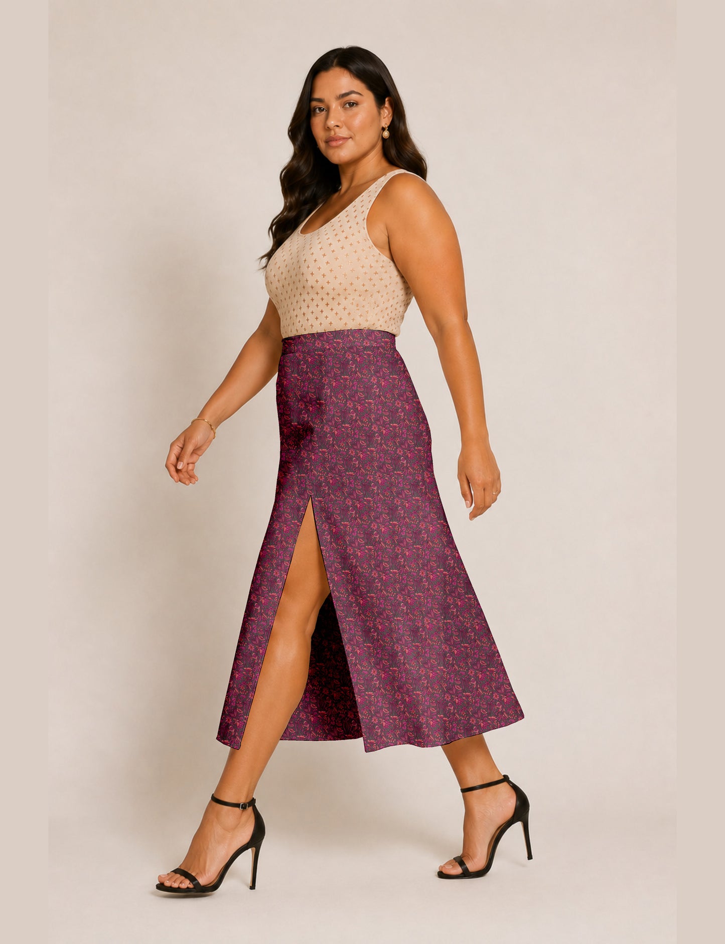 Woman wearing a yellow and black micro patterned A-line skirt with front slit, paired with beige sleeveless top and black
