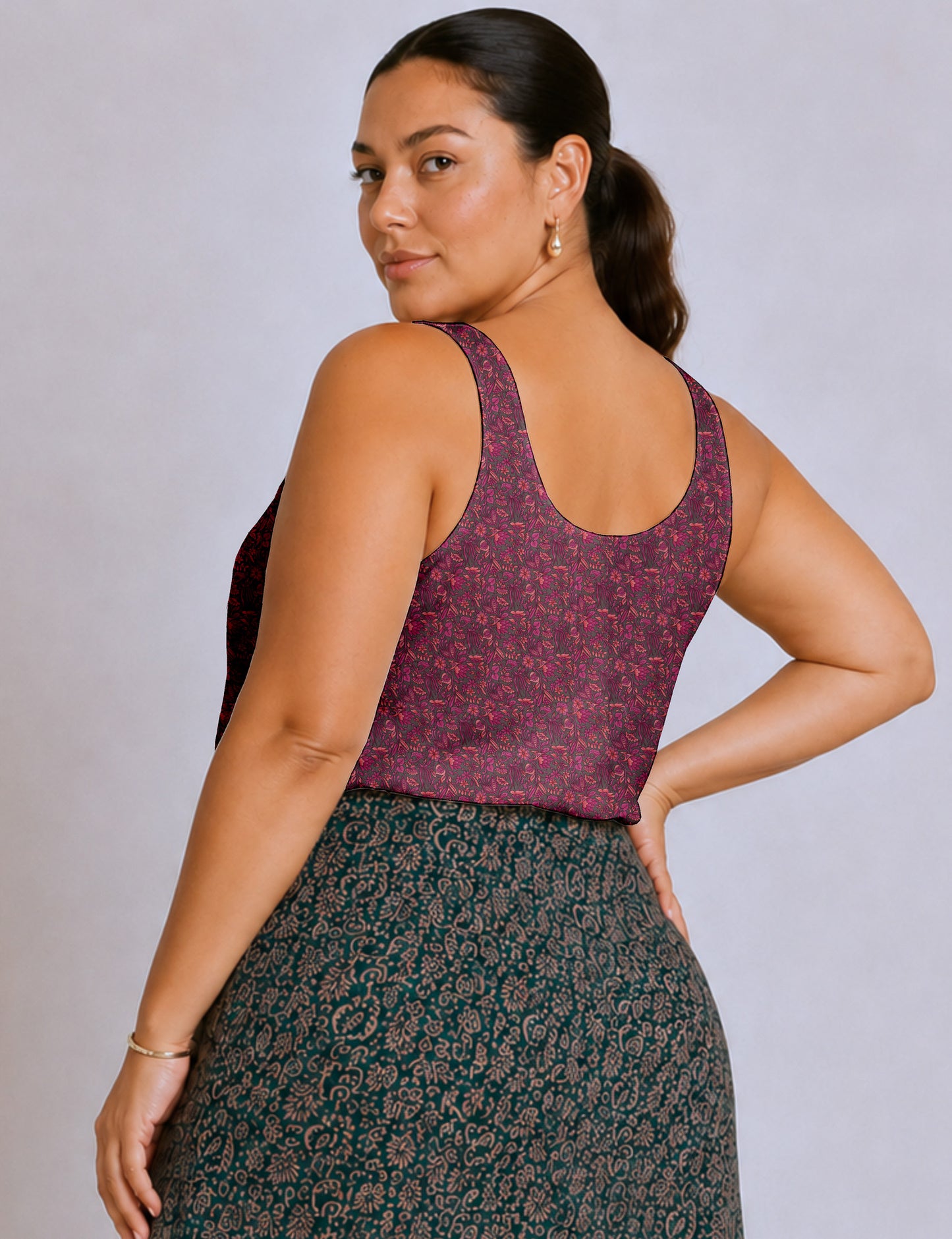 Women's sleeveless blouse with a relaxed straight fit, wide scoop neckline, deep scoop back, and hip-length silhouette.