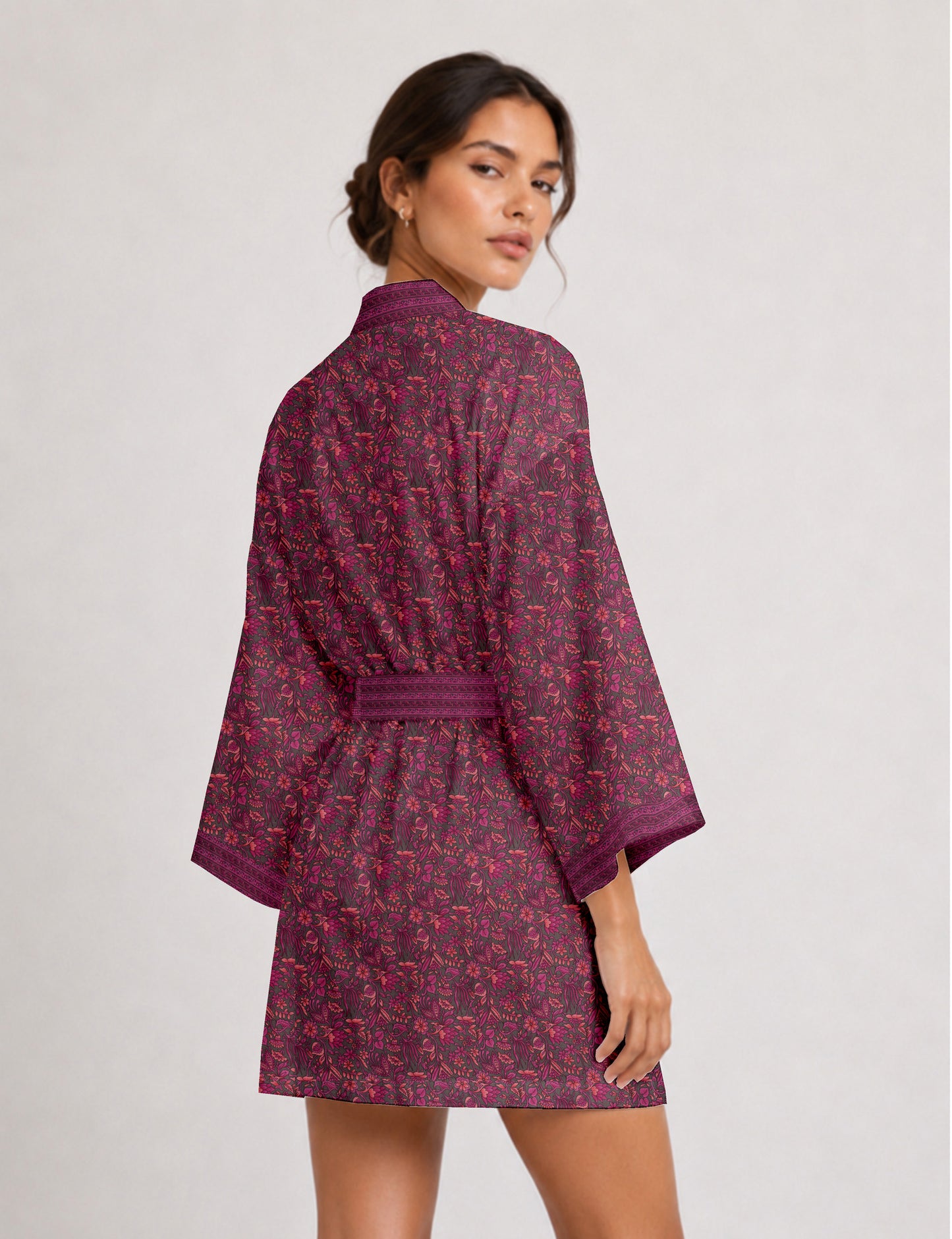 Short kimono robe with wrap front, V-neckline, wide sleeves, waist tie, and concealed skort detail.
