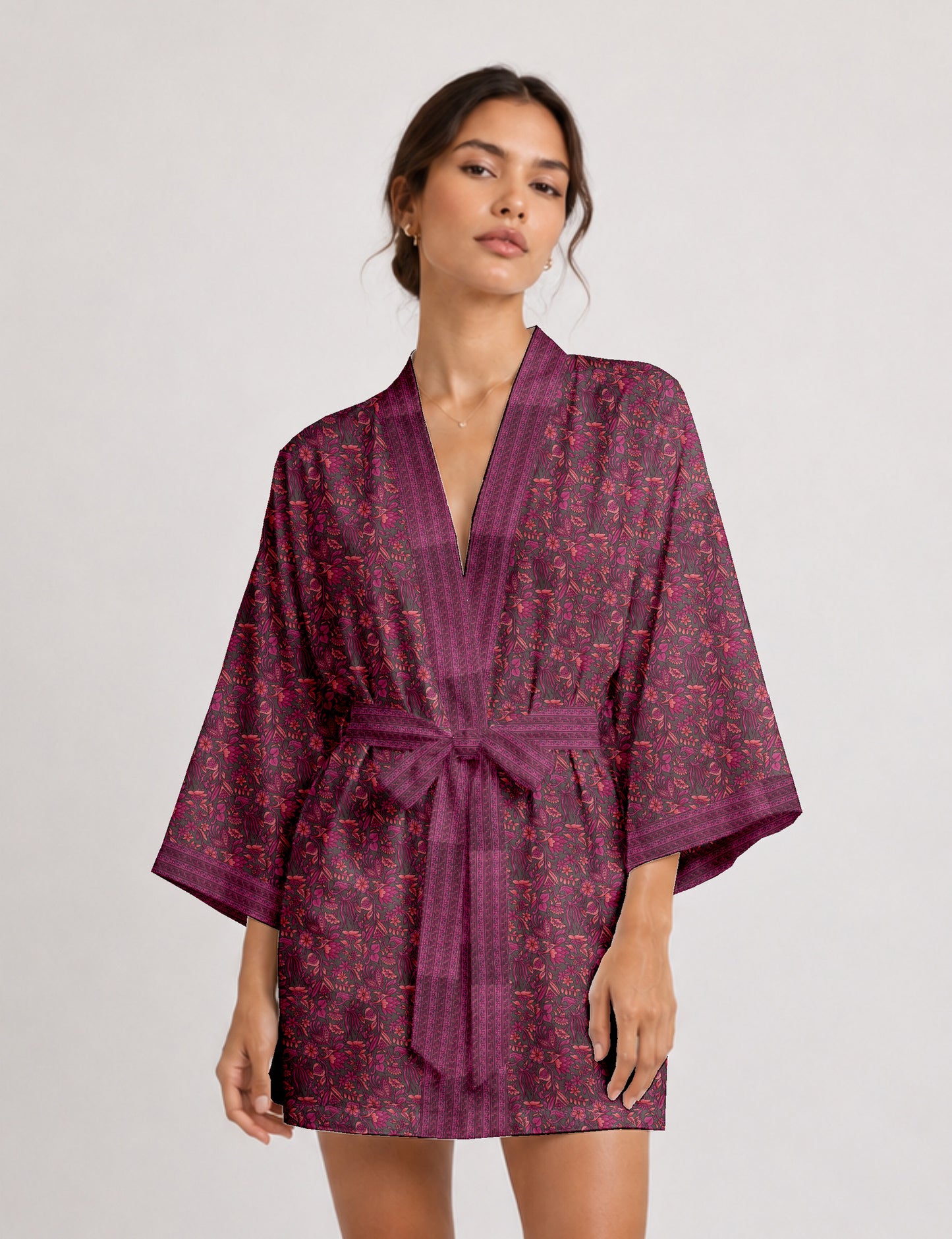 Short kimono robe with wrap front, V-neckline, wide sleeves, waist tie, and concealed skort detail.